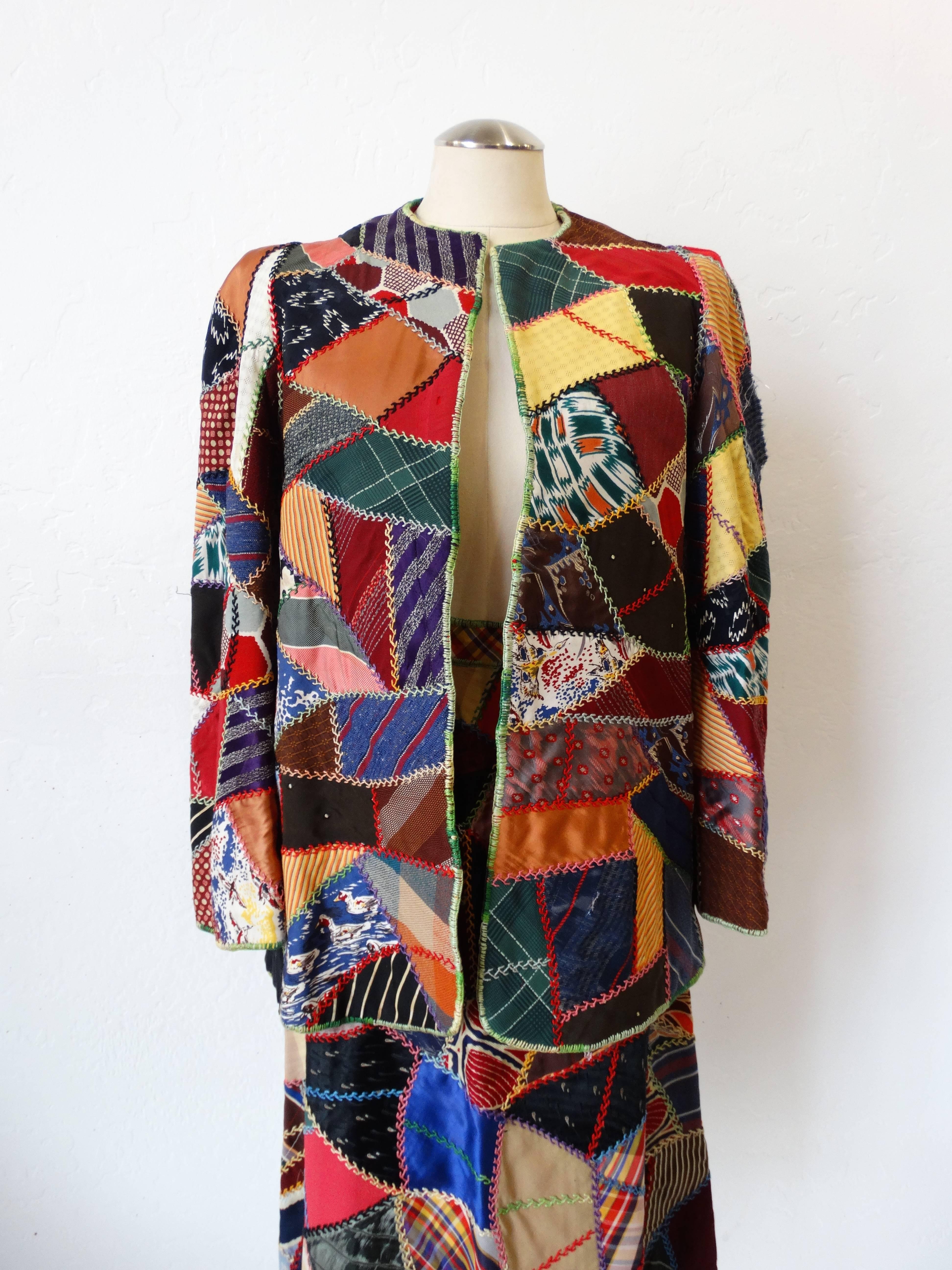 Super seventies patchwork jacket and skirt set! These pieces are covered in prints galore! Patches of multicolored print with contrasting rainbow stitching throughout. Skirt features a high waisted fit and knee length, zips up the side and fastens