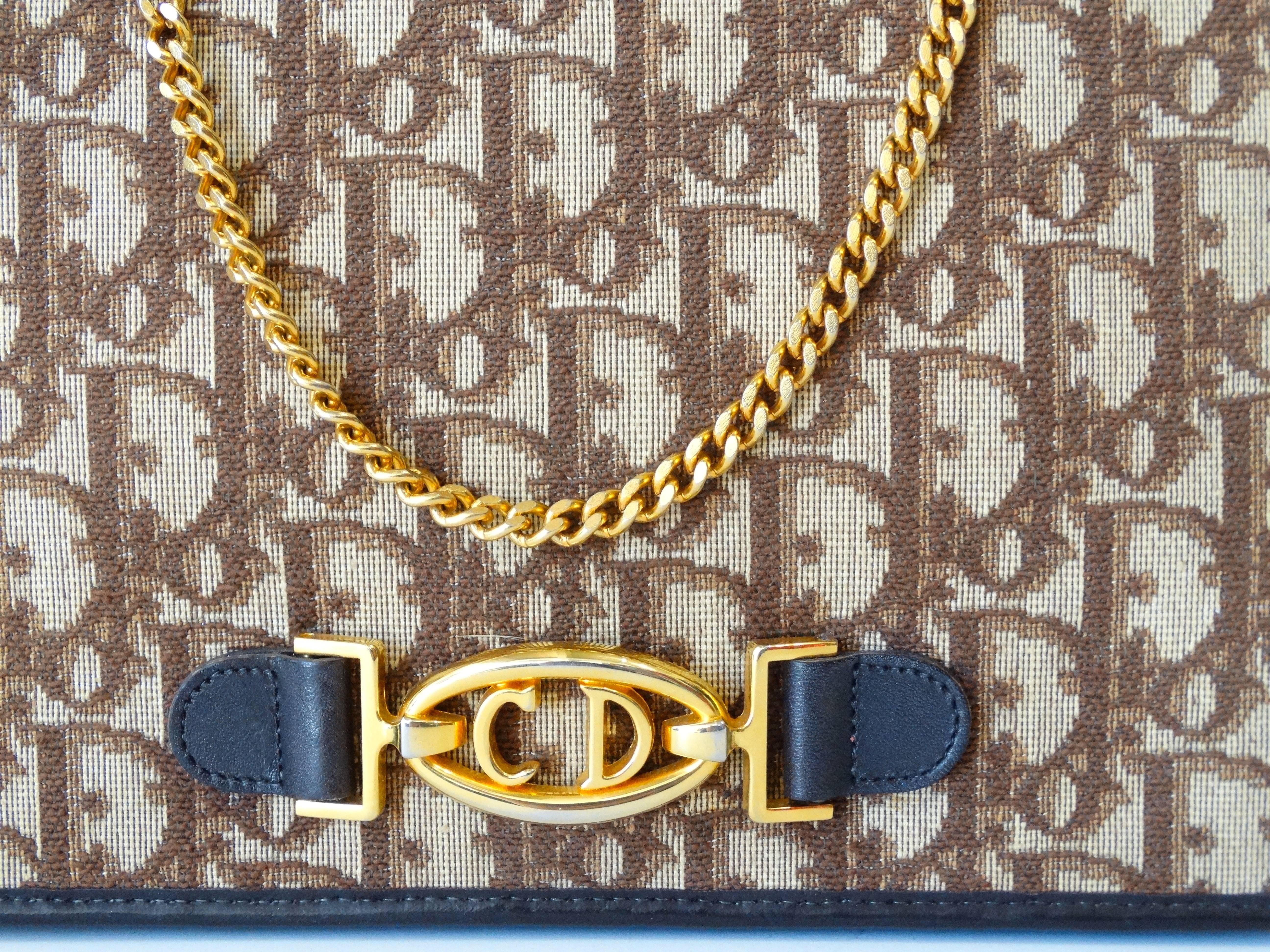 Haven't you heard? Monogram prints are in! Rock this timeless shoulder bag from 1980s Christian Dior. Classic Dior Monogram print all over in shades of tan and brown. Dark brown leather piping around the edges as well as on the sides of the CD gold