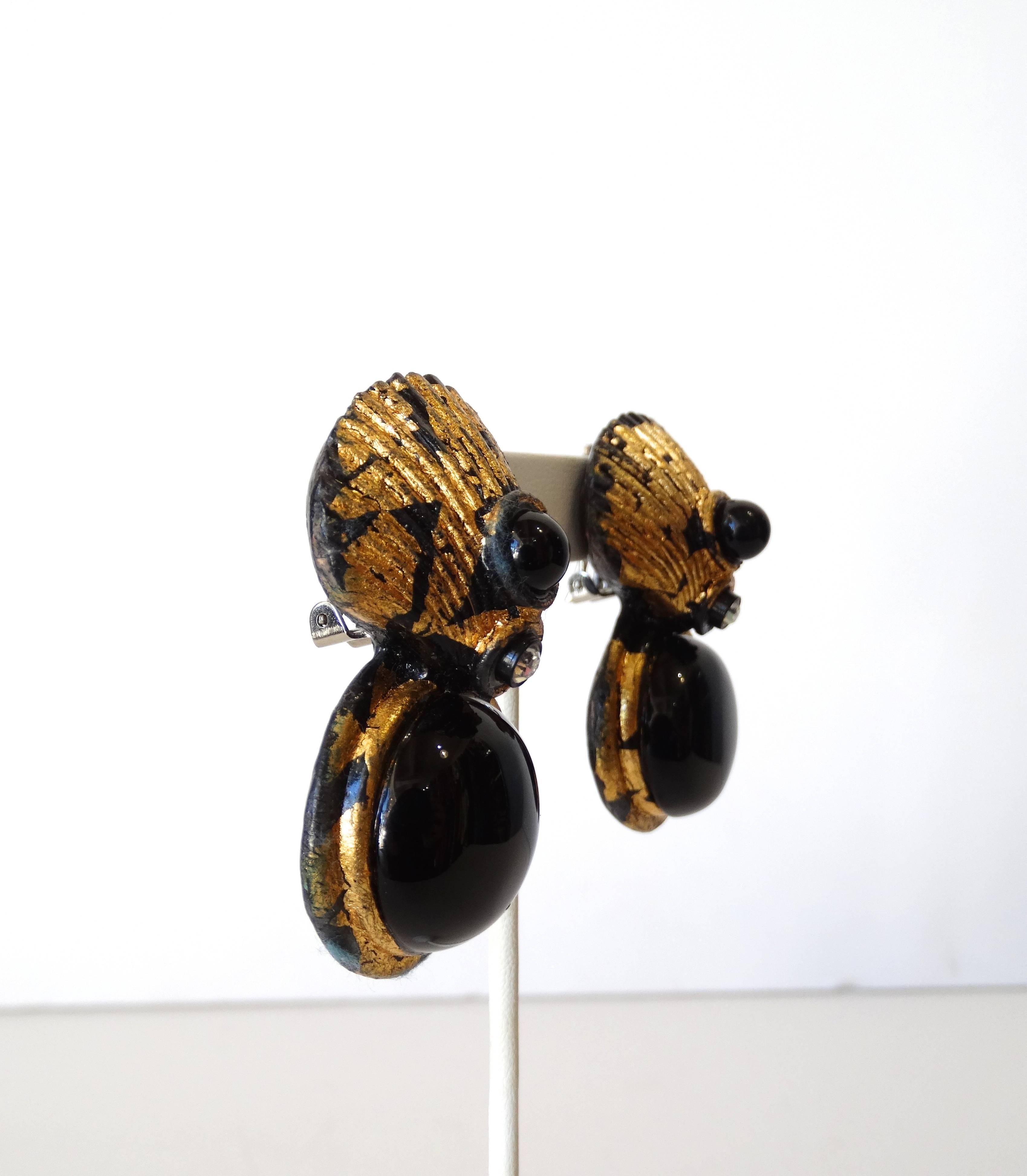 Channel your inner mermaid with our 1980s clamshell clip on statement earrings! Unique gold gilt and black toned metal accented with black enamel orbs and single rhinestones in the middle. Clip on backs, unsigned.  

2.25 in long, about 1 in wide. 