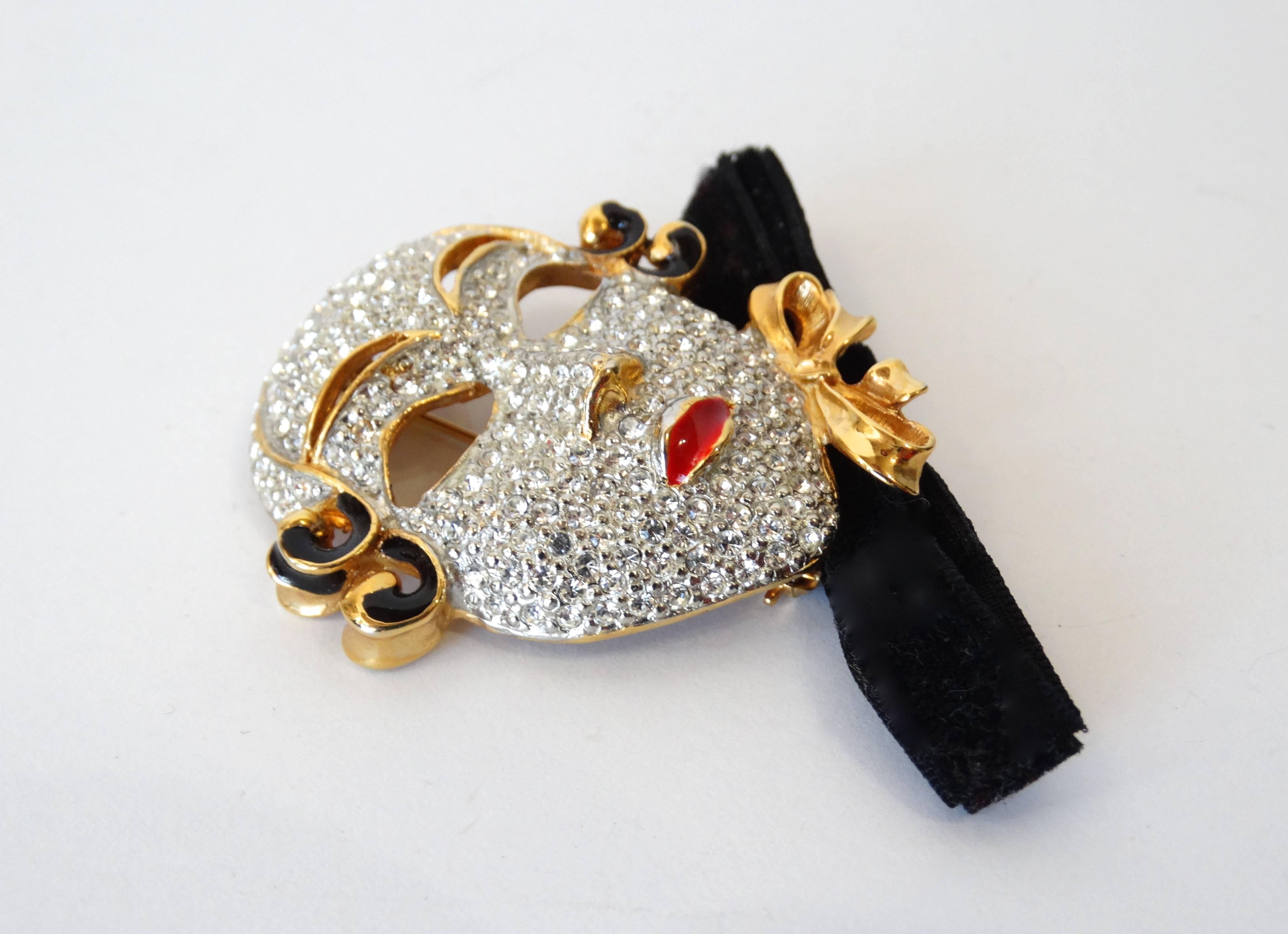 Incredible 1980s rhinestone mask brooch from Ugo Correani! Ugo Correani pieces are hard to come by, he had a hand in designing for Chanel, Versace and many more in the 70s and 80s! Silver metal mask face accented with crystalline rhinestones and