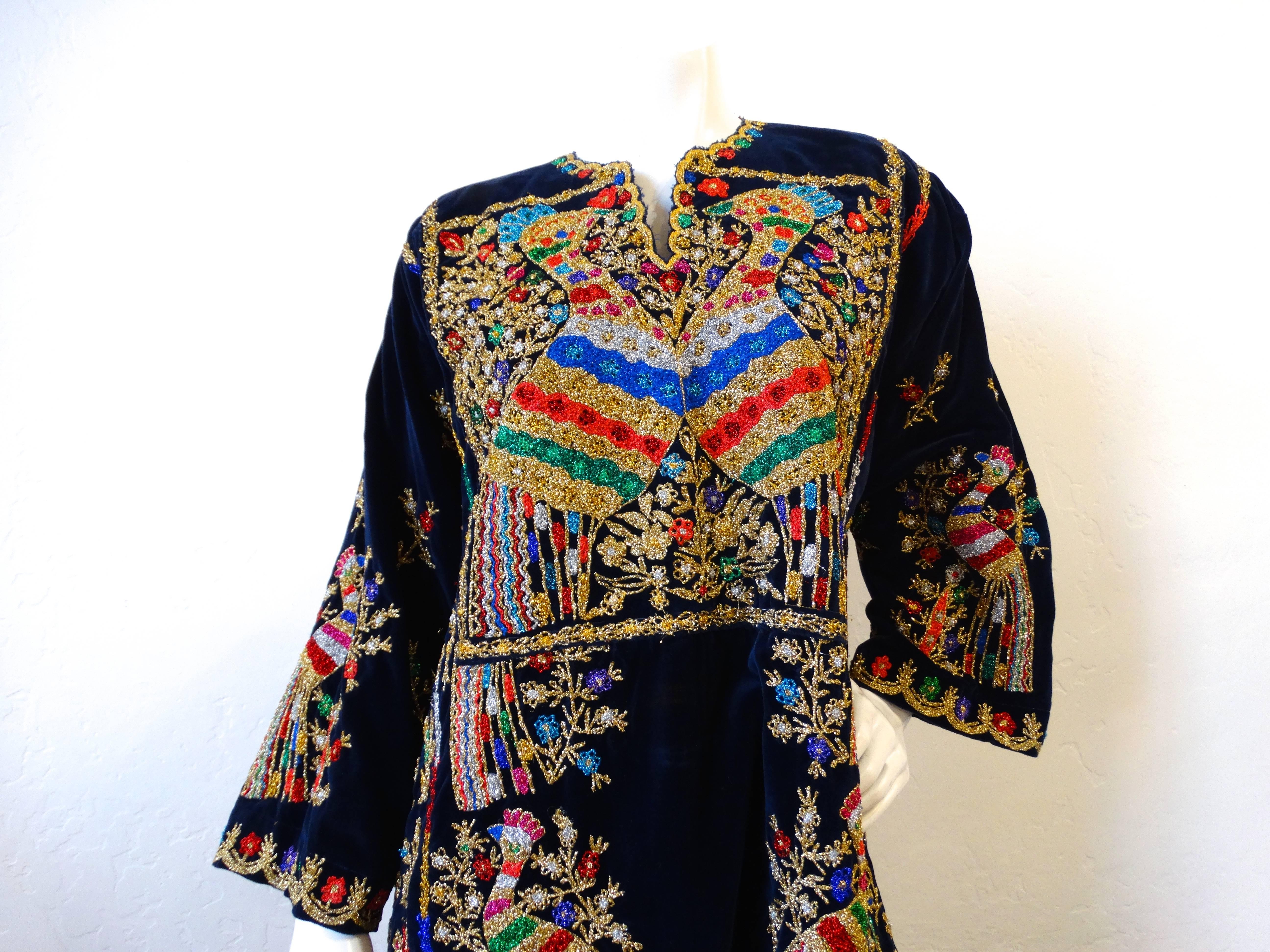 Incredible 1970s Middle Eastern- India designed hand embroidered kaftan! Deep, dark blue velvet fabric with rainbow and gold embroidery throughout. Intricate metallic hand stitched peacocks, flowers, foliage-on the bust, down the skirt and on each