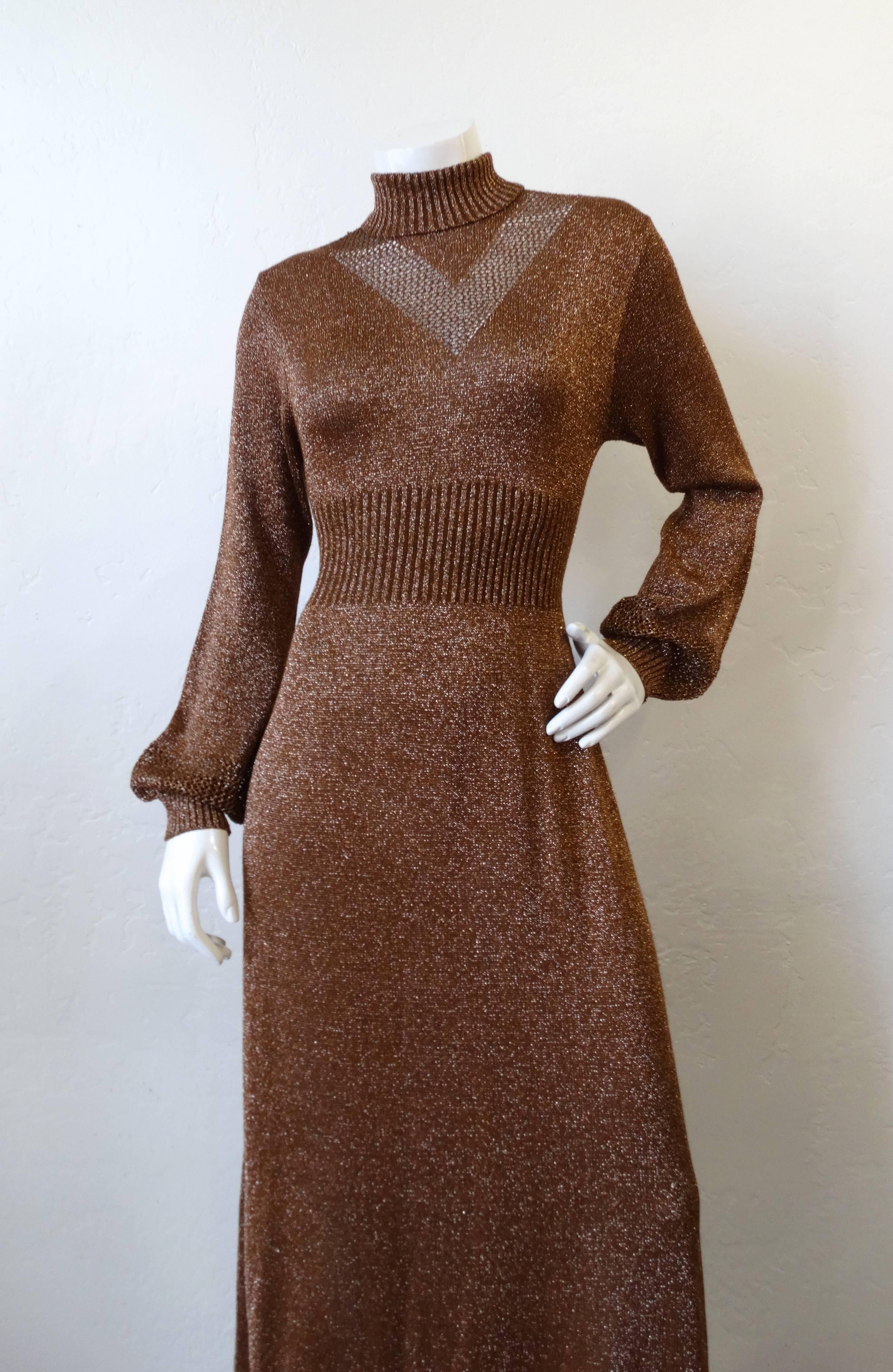 We love Lurex- and you will too with our 1970s Wengilli Lurex knit dress! Made of a super shiny bronze glitter lurex knit fabric with a chevron stripe panel on the chest in a more open weave. Ribbed turtleneck, waistline and cuffs. Maxi length and