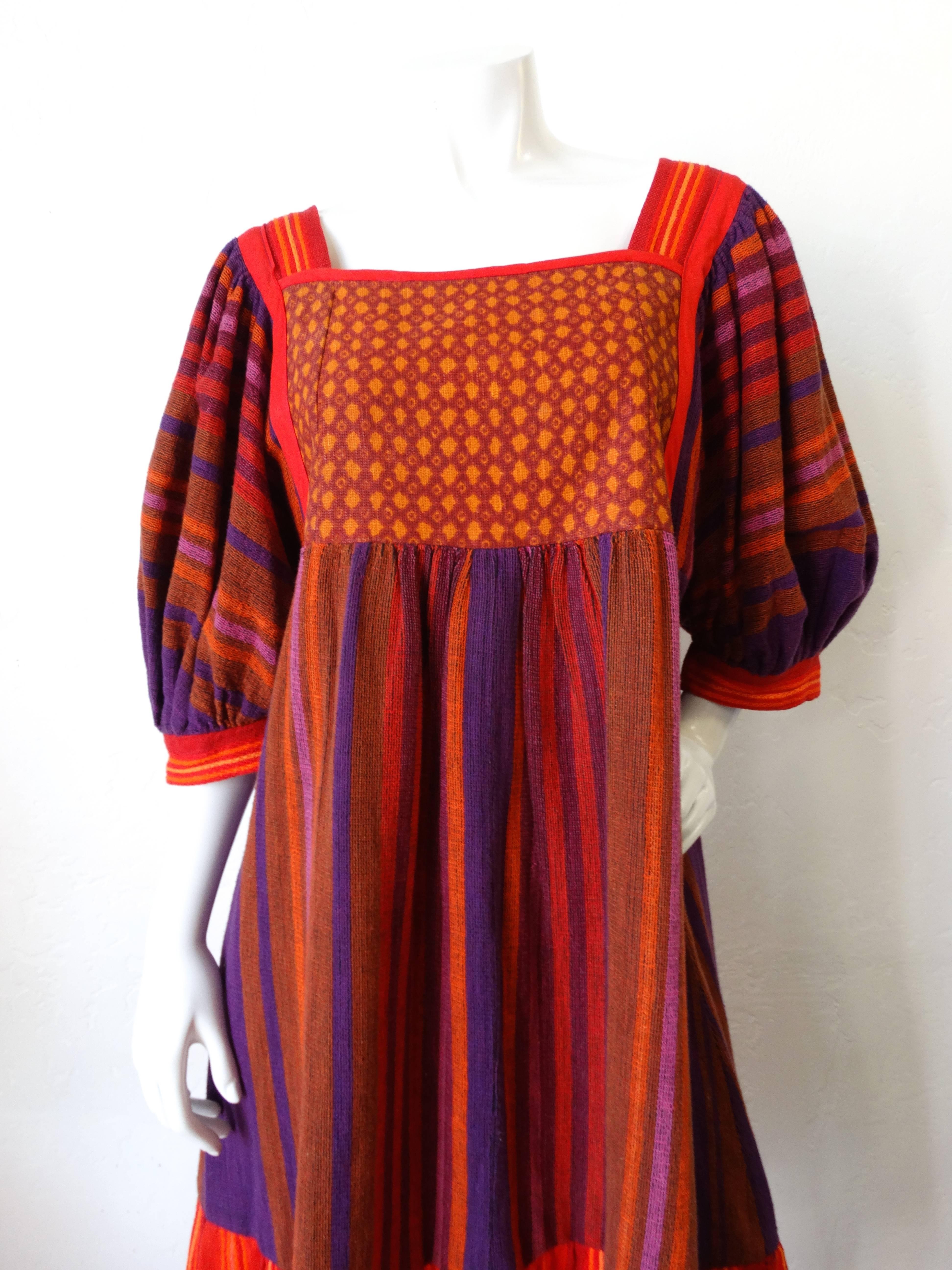 Channel the spirit of the 1970s in our amazing dress from Israeli designer Rikma! Intricately woven cotton in warm colored contrasting striped patterns throughout. Super flattering baby doll-like silhouette with flouncy bell sleeves. Looks amazing