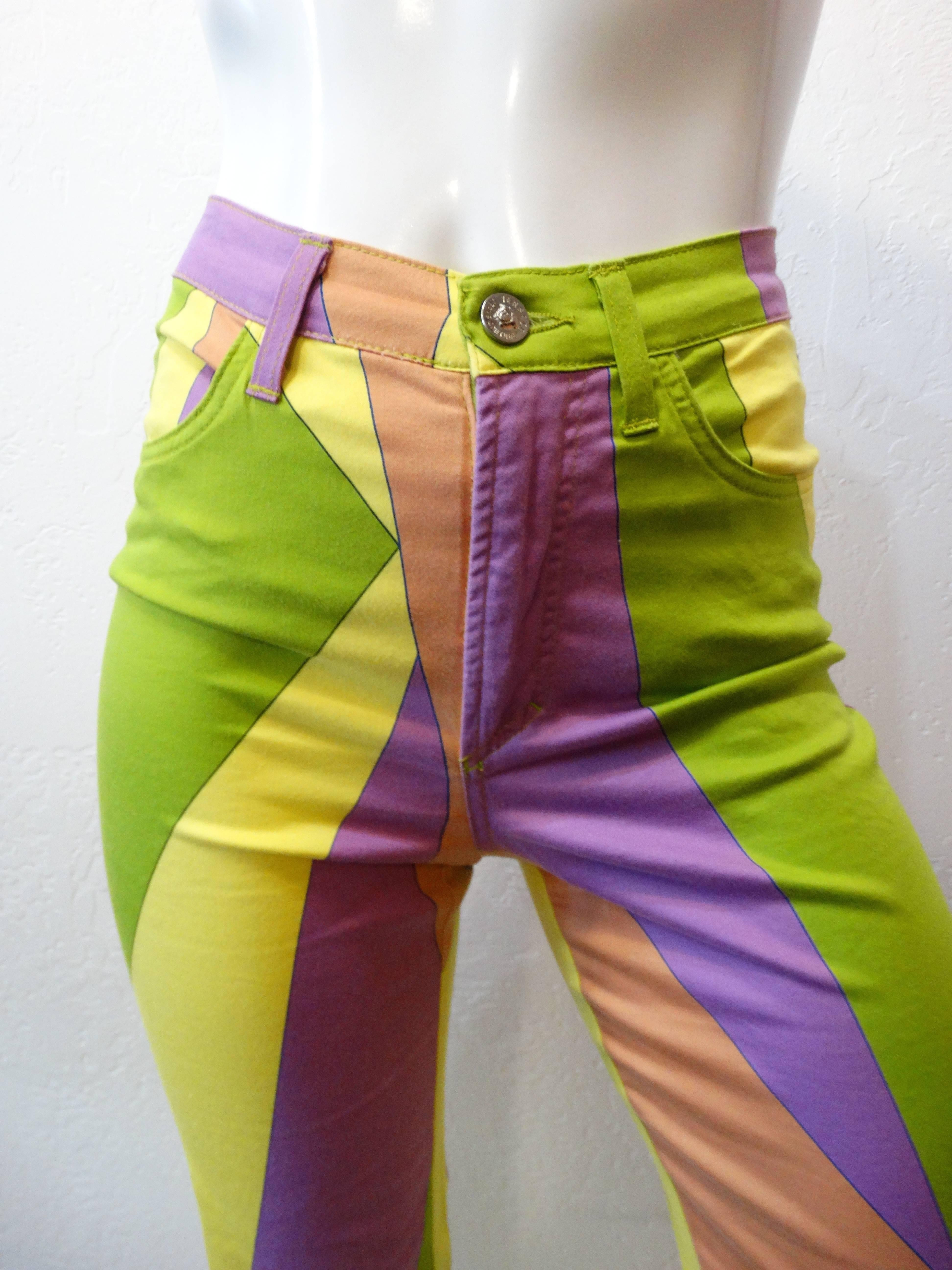 Funk it up in our 1990s Versace geometric printed pants! Yellow, green, peach, and lavender geometric print all over on soft cotton fabric. Jean-like construction,  4 pockets. High rise fit with a slightly tapered leg. Leather Versace patch on the