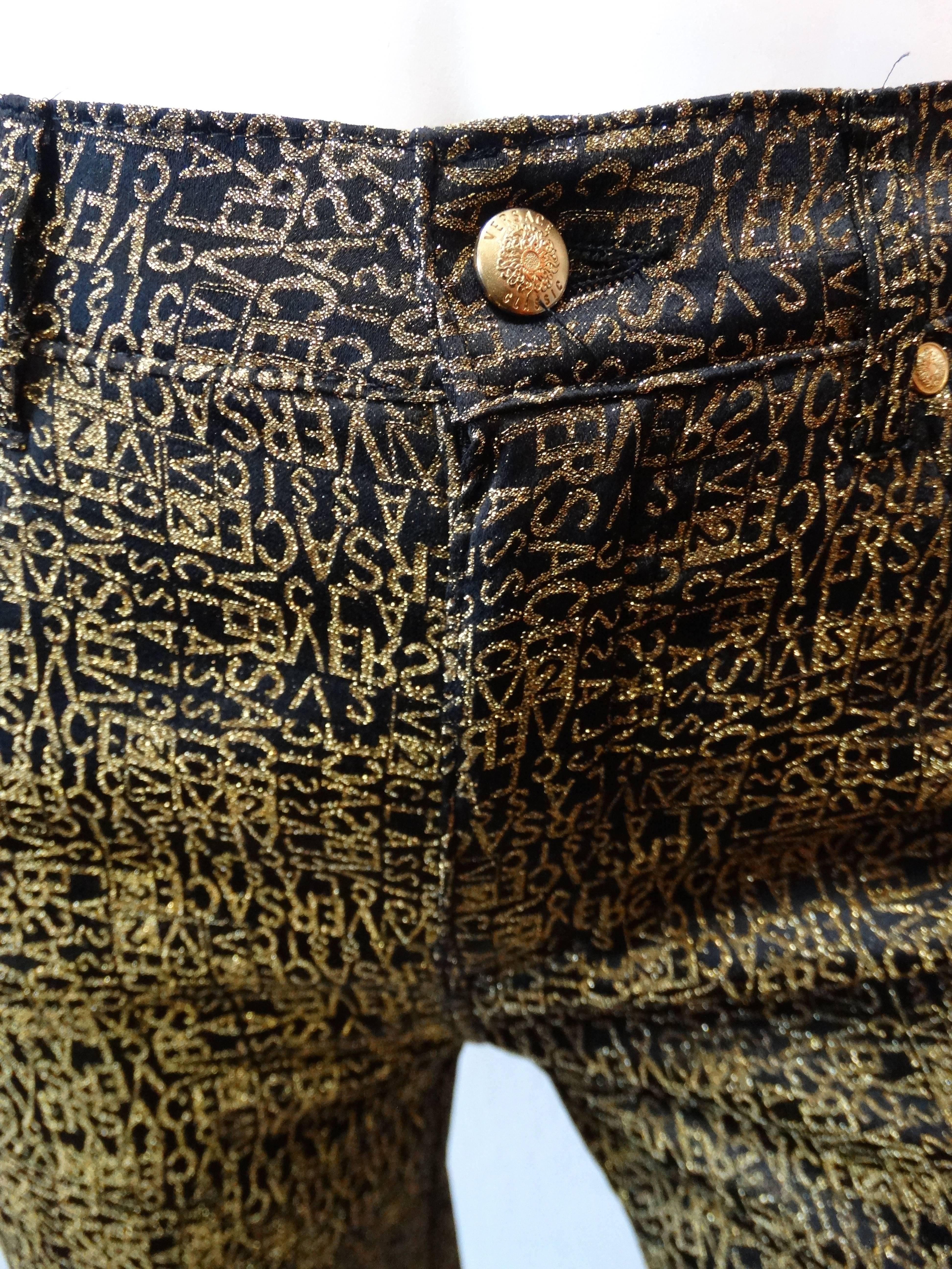 Amazing 1990s Versace monogram pants! Black and gold glitter Versace repeating print all over. Four pocket construction, clear versace patch on the back right pocket. High rise fit with a tapered leg. Zips up the front and buttons at the waist.