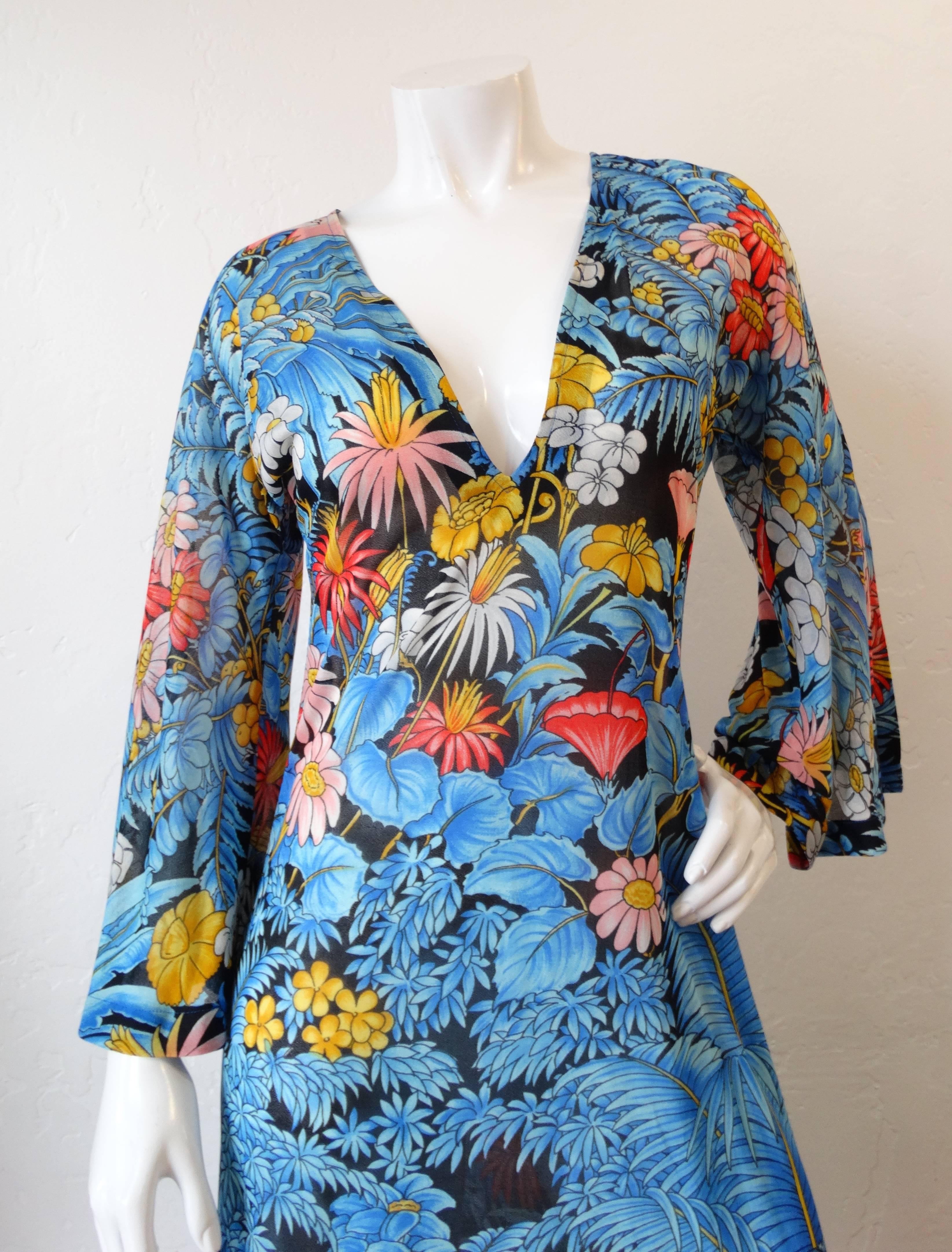 Rock the floral trend in our incredible 1970s maxi from Israeli swim designer Gottex! Slightly sheer fabric printed all over with an intricate floral pattern- in shades of primary colors and black. Angel-wing sleeves with a slit on either side.