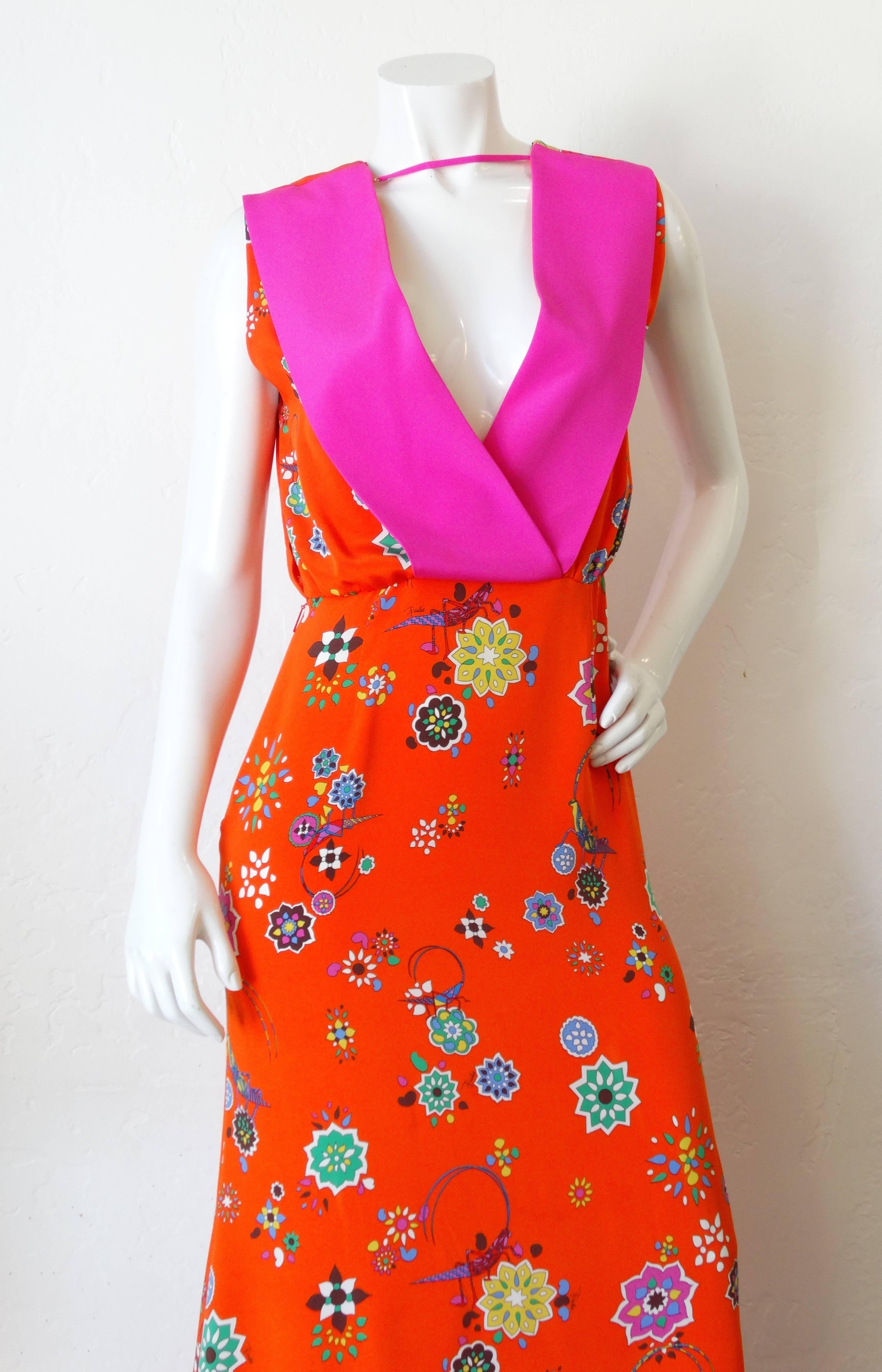 Incredible 21st century Emilio Pucci printed dress! Gorgeous orange floral print with precious grasshopper motifs throughout in multicolor shades . Hot pink collar with a matching ribbon that snaps across the neck. V-neck cut front and back, dress