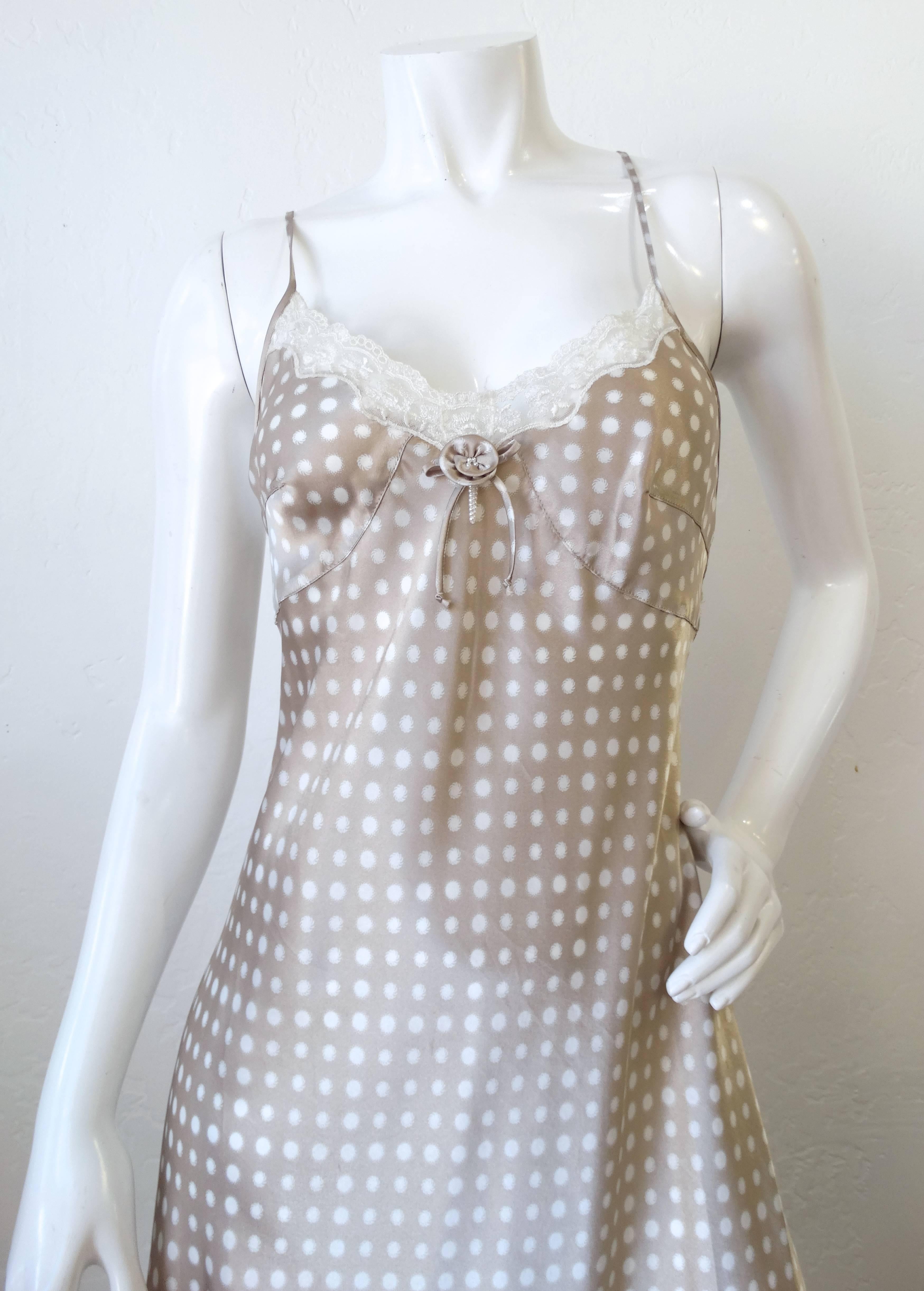 Get in on the slip dress trend with our adorable Christian Dior polka dot slip! Made of a silky satin, with a taupe and white polkadot all over print. trimmed along the bust with creamy white lace. Flower and bow detail at the center of the bust.