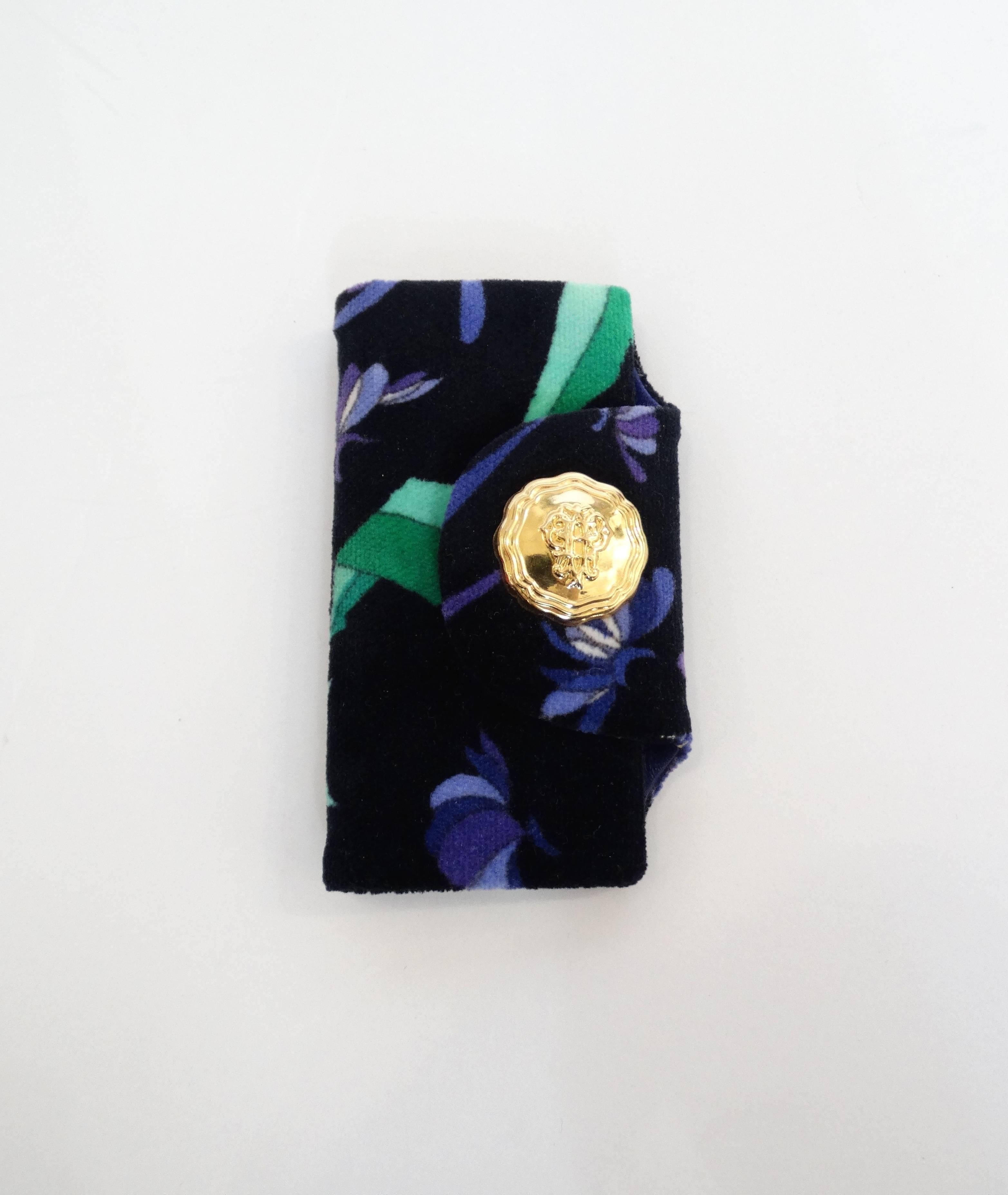 Keep all your keys in one place with our Emilio Pucci key case! Made of a super soft velvet with classic Pucci swirl pattern in shades of blue, violet and green. Fully lined with violet leather. Hooks all along the top of the case for each of your