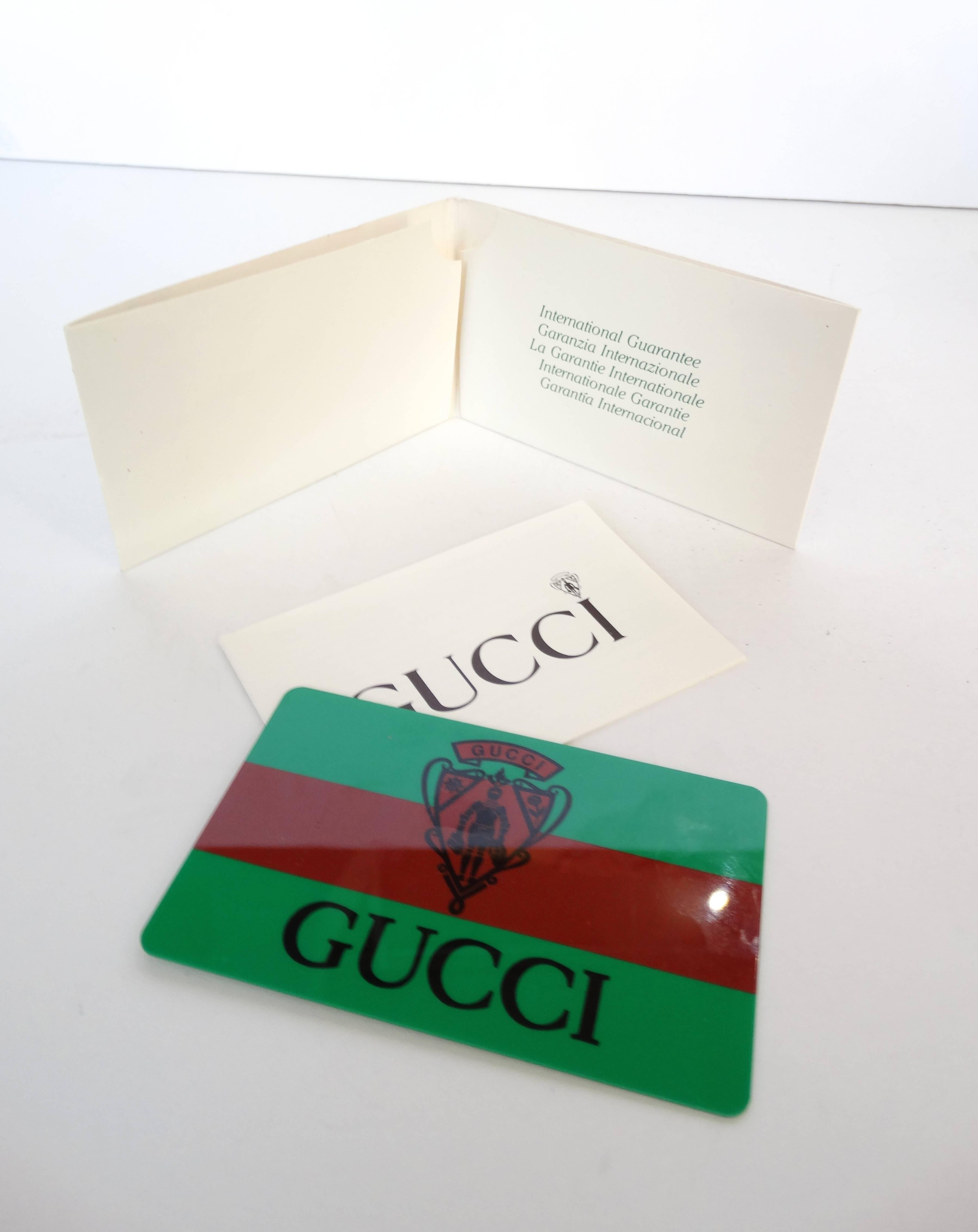 Have a Gucci watch for every day of the week with our watch and bezel set! Comes with gold metal Gucci bangle watch and original box full of an array of colorful bezels. Includes green and red classic stripe Gucci bezel. Signed Gucci Made in Italy
