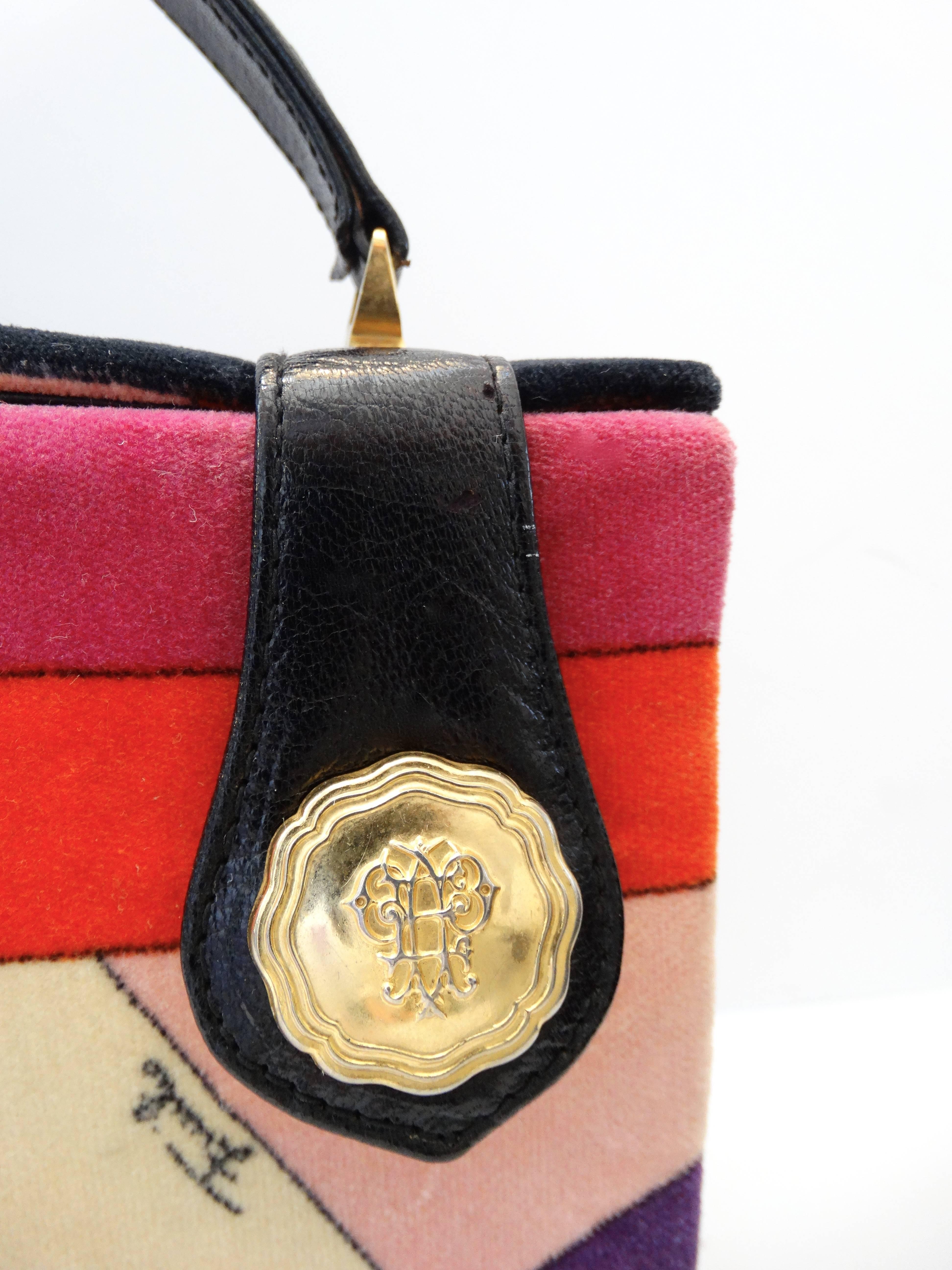 Amazing 1970s box bag from iconic designer Emilio Pucci! Made of Pucci's signature cotton velvet fabric- printed with a geometric pattern in shades of red, pink and cream. Top flap is secured with two snaps, topped with two gold metal Pucci emblems.
