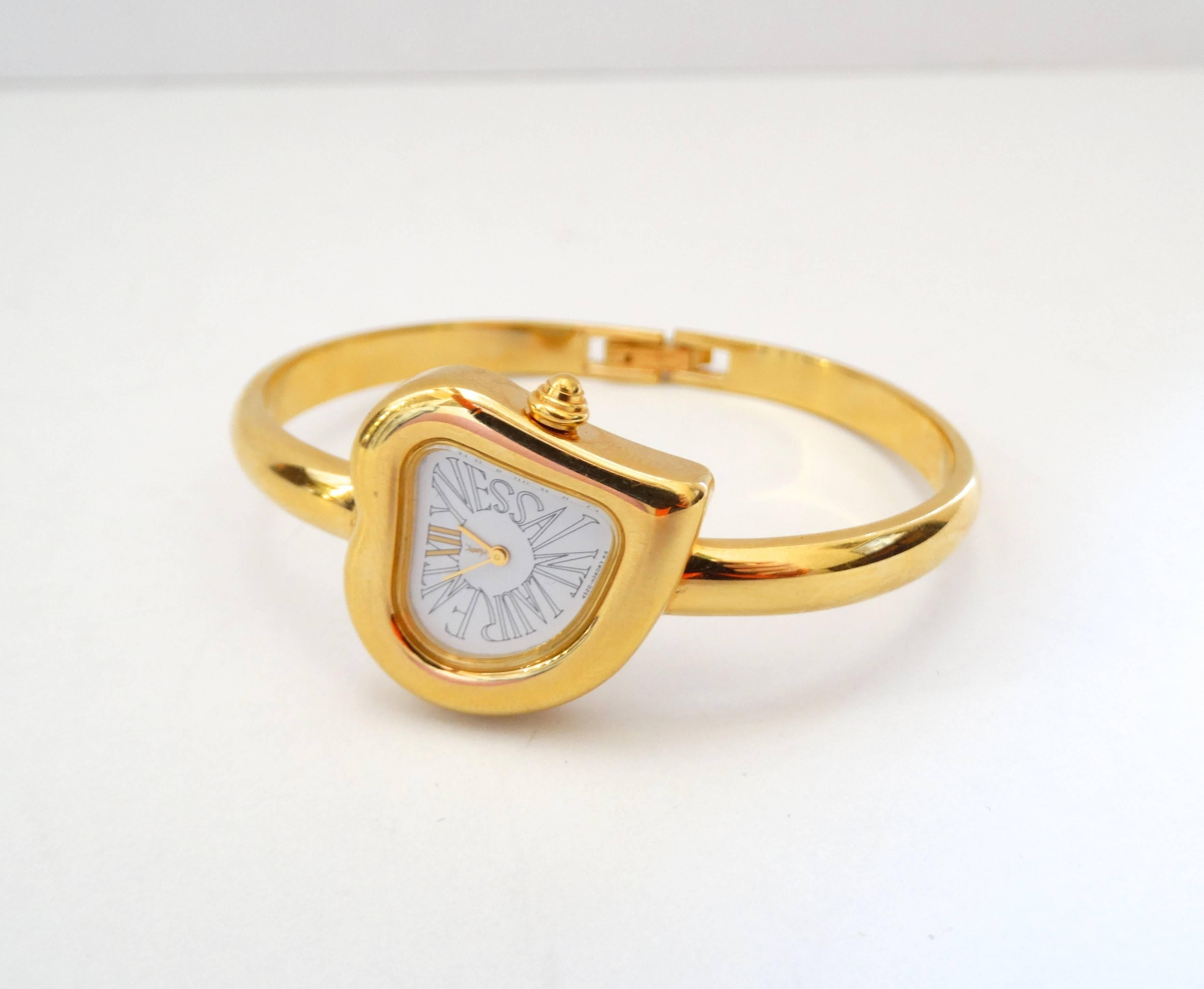 The perfect gift for your lover or even yourself this Valentines Day! Adorable Yves Saint Laurent Heart Bangle watch! Heart shaped face with YVES SAINT LAURENT spelled out in a Roman font in place of the numbers. Thin, stylish bangle style in a