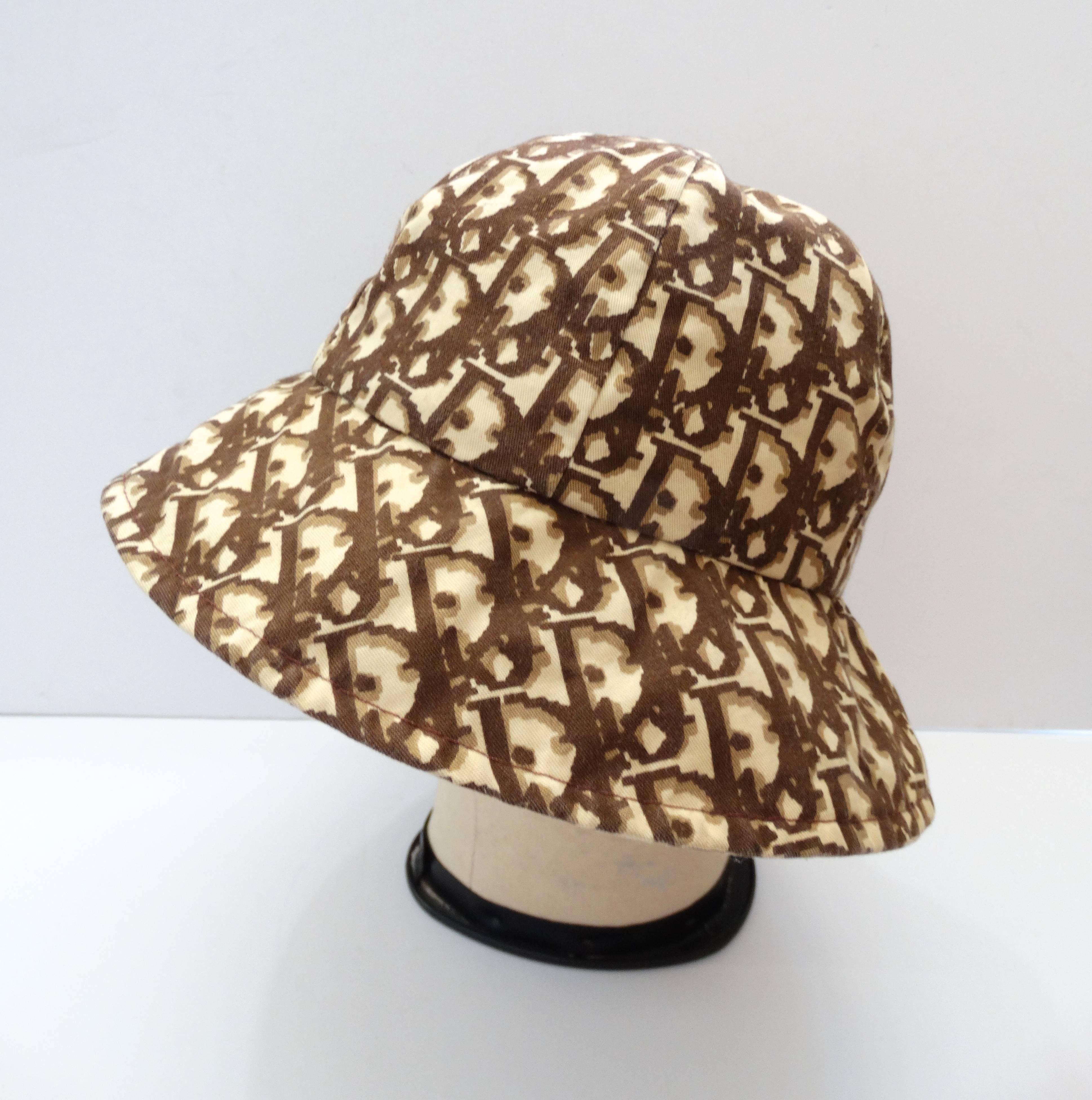 Finally the perfect bucket hat- with a designer twist! Printed with Christian Dior's signature monogram Dior pattern throughout, in shades of tan and brown. Classic bucket hat construction, can be worn with rim up or down. Cotton lined