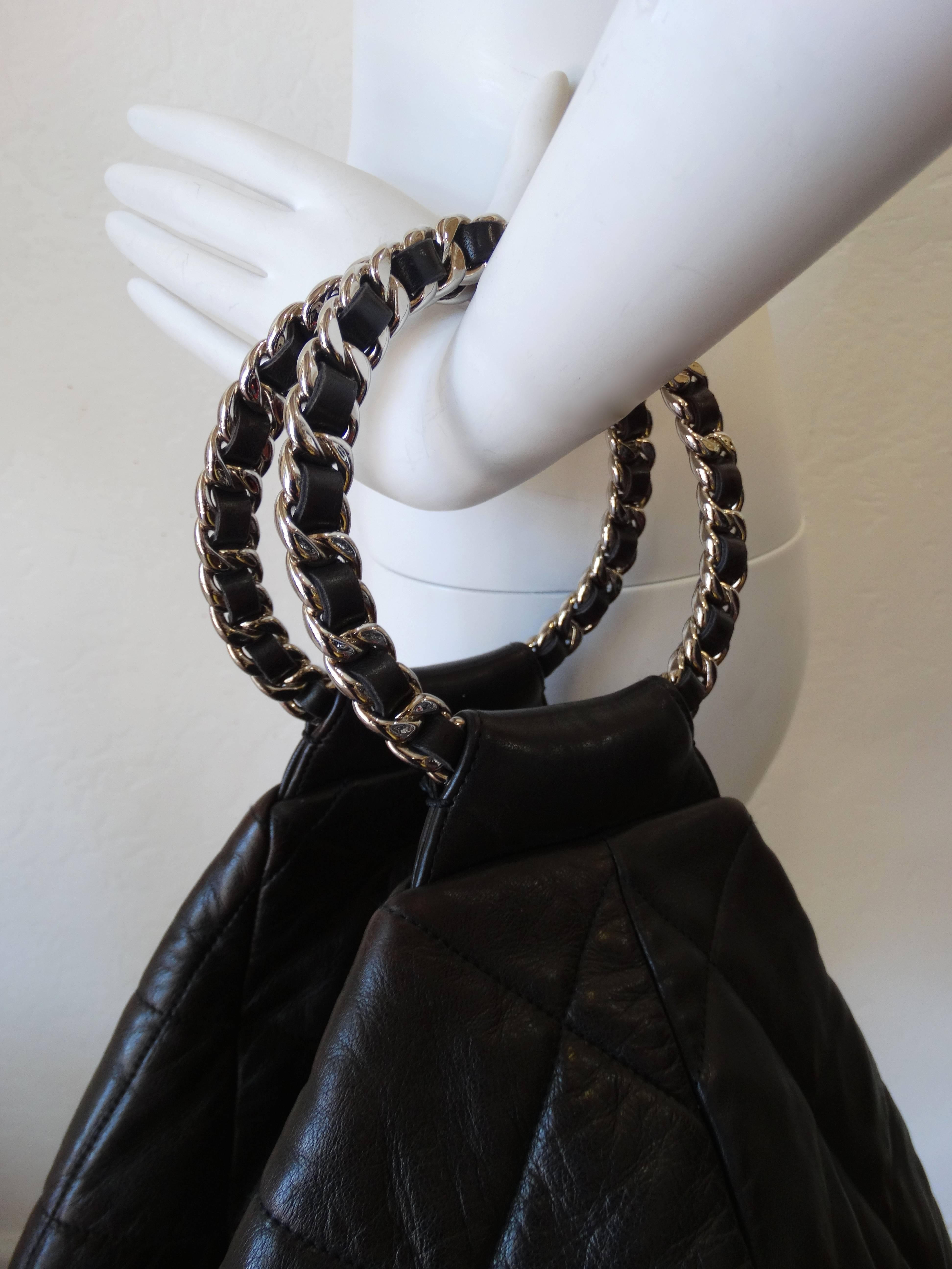 The perfect back for carrying all your daily must haves- the black quilted Chanel hobo bag! Made of a rich and soft black calfskin leather, with the classic Chanel quilting stitched in. Has two chain rings woven with black leather for handles. Zips