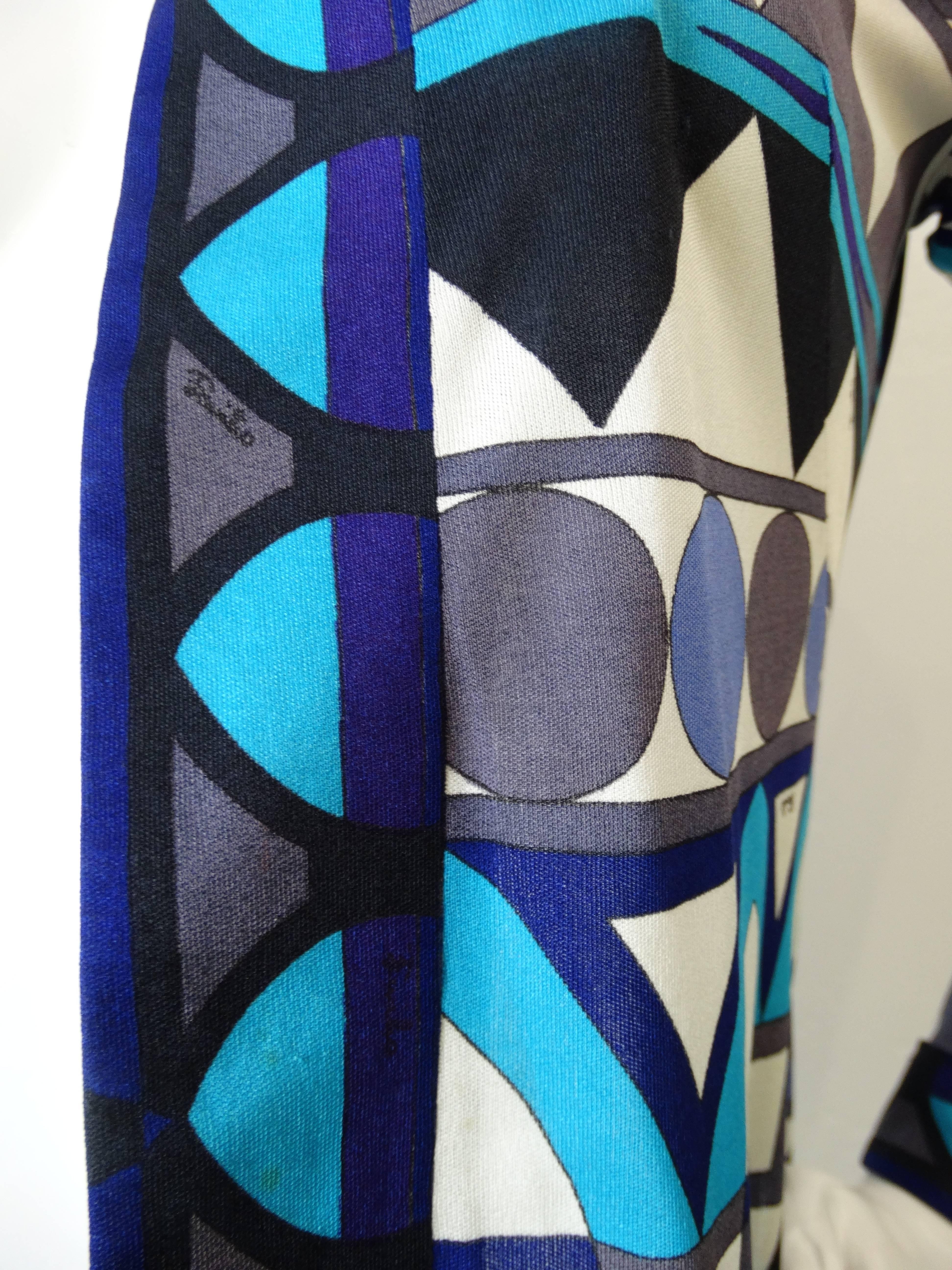We are Pucci obsessed and you will be too with our amazing 1970s Pucci cardigan! Open construction cardigan silhouette with intricate, oh so Pucci geometric print. Shades of blue, black, purple and white. Slightly flared sleeves give some 1970s