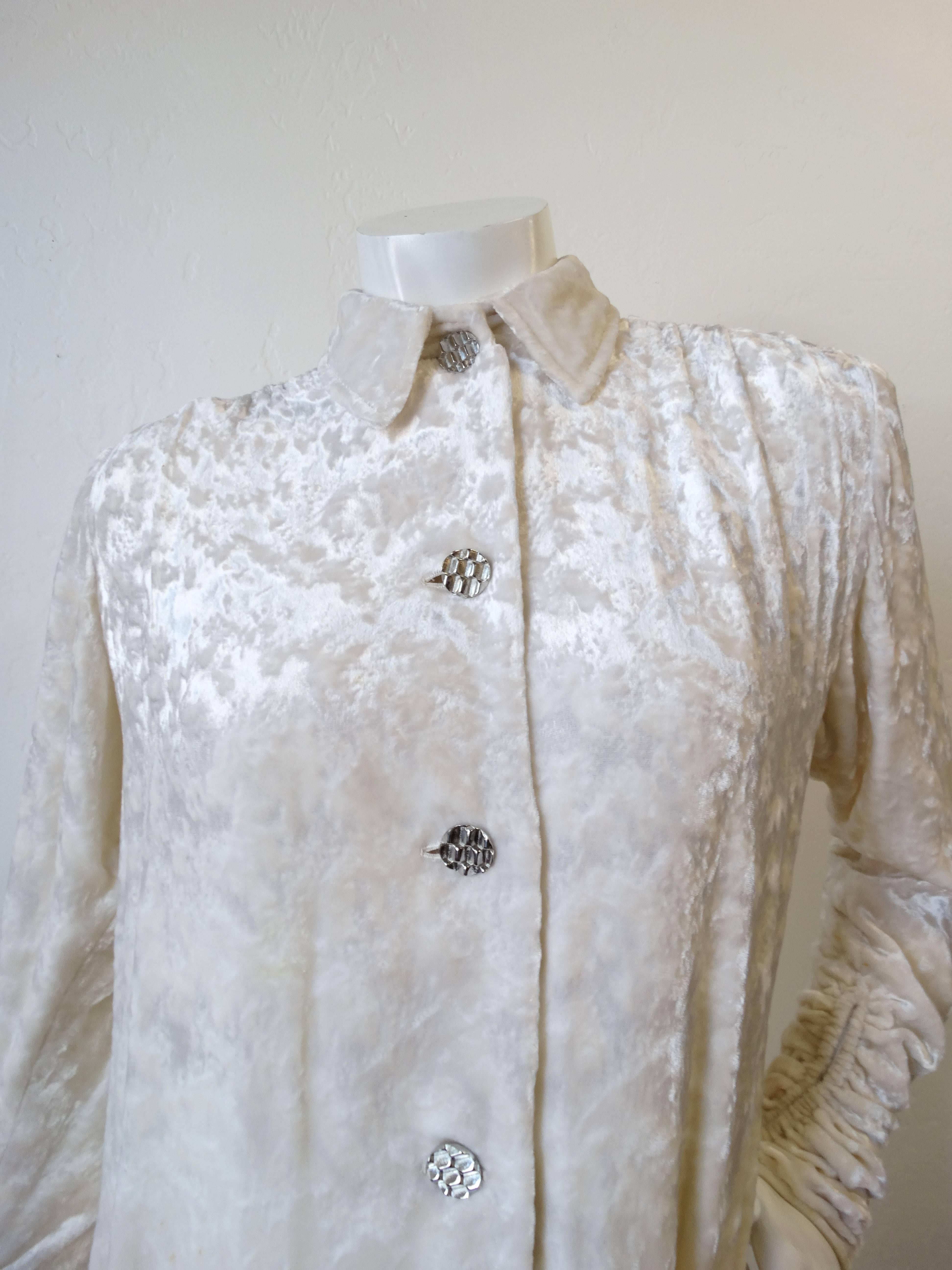 We love a good Galanos- and this piece is no exception! Elevate your next outfit with our amazing 1980s Galanos velvet button down! Rich crushed velvet in a shade of creamy white, contrasted with circular silver buttons. Unique ruched details on the