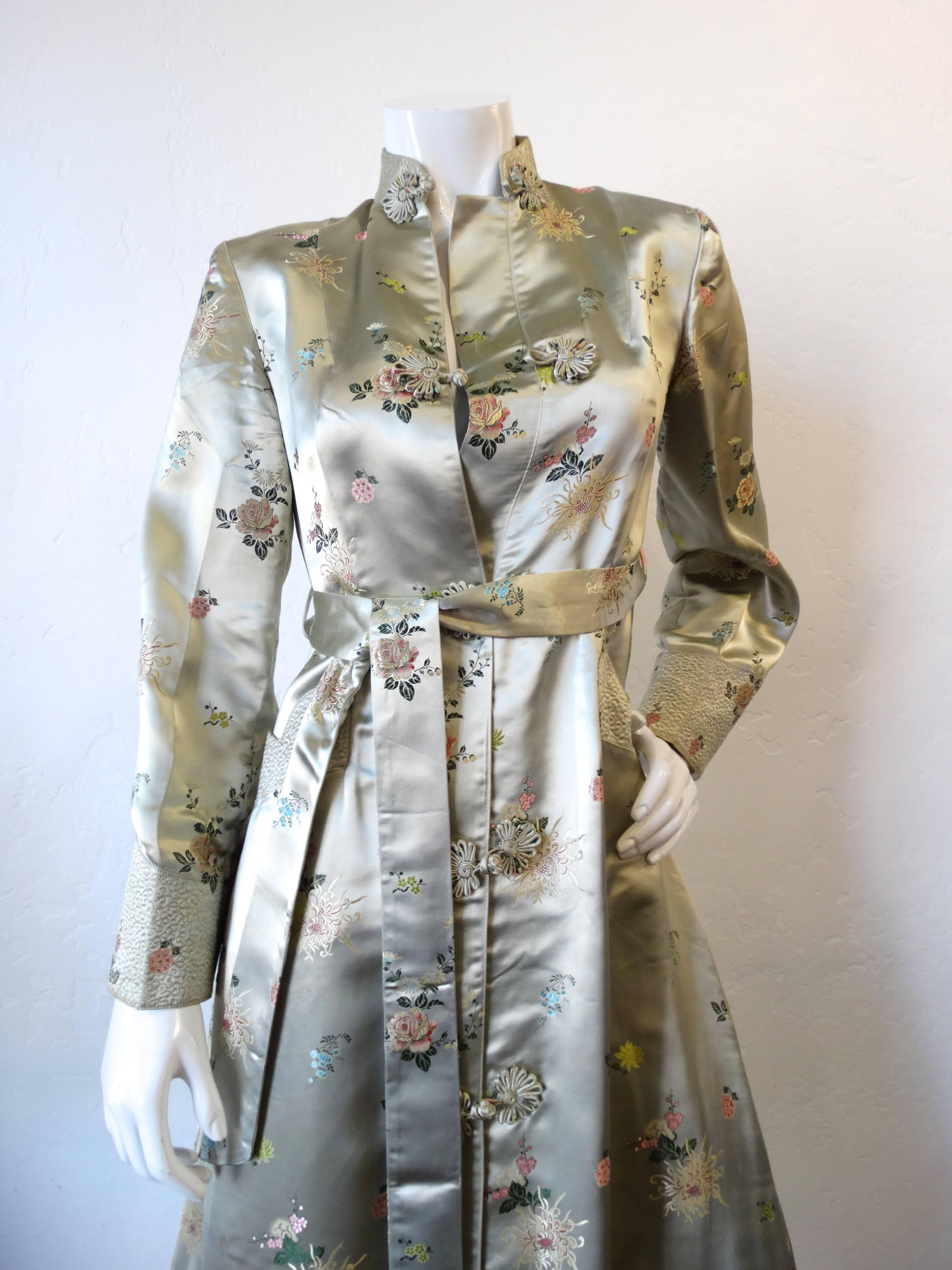 Incredible vintage Cheongsam inspired satin coat! Made in Shanghai- this piece is made of silky Chinese satin with intricate floral embroidery. Detailed stitching on the cuffs as well as the pockets at either side of the waist. High neckline,