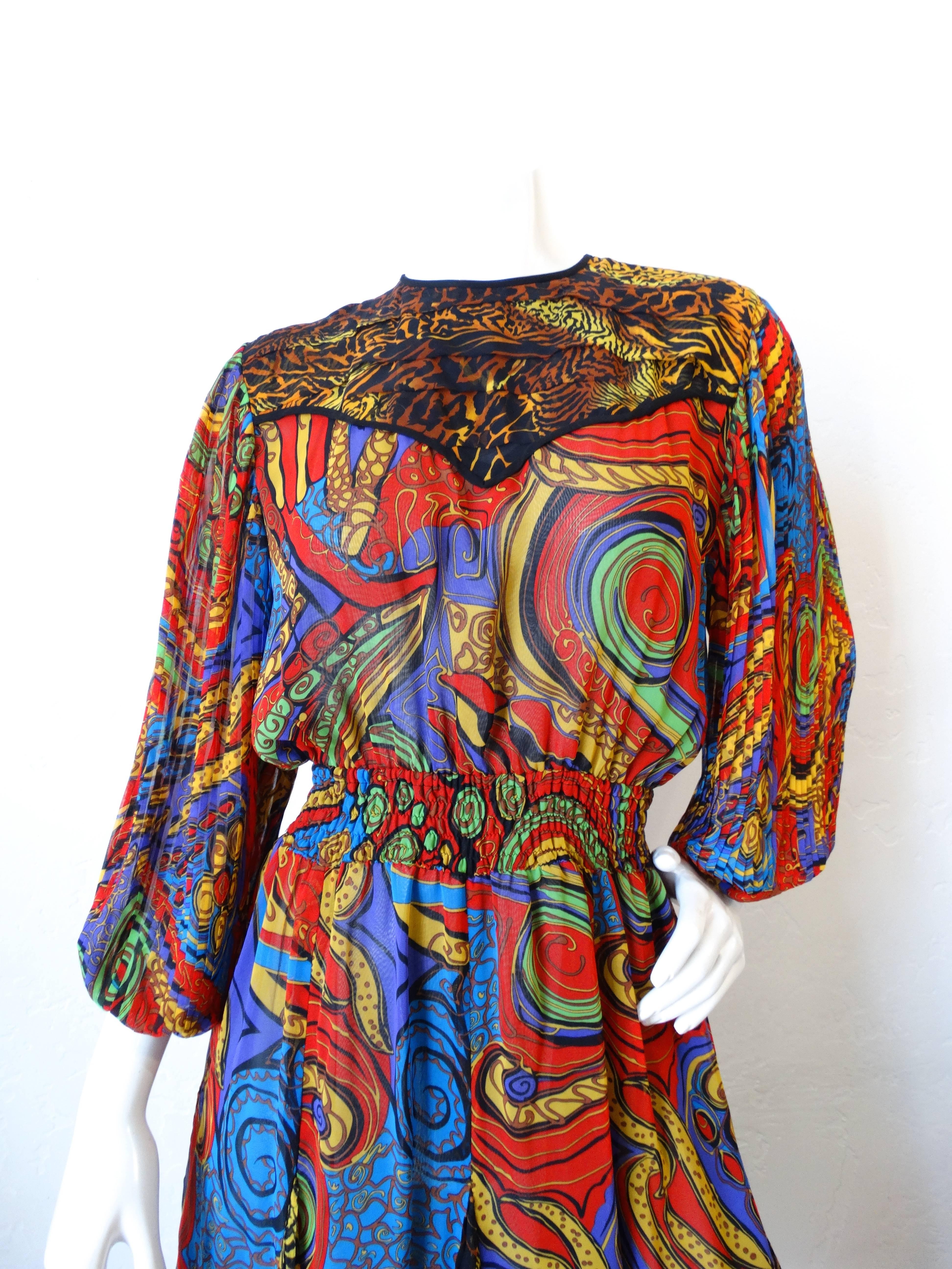 Diane Freis fans rejoice! This incredible 1980s Diane Freis dress in printed in brilliant swirling colors with contrasting leopard print pattern on the yoke. Blouson sleeves, with permanently pleated texture. Flattering elasticized waistline allows