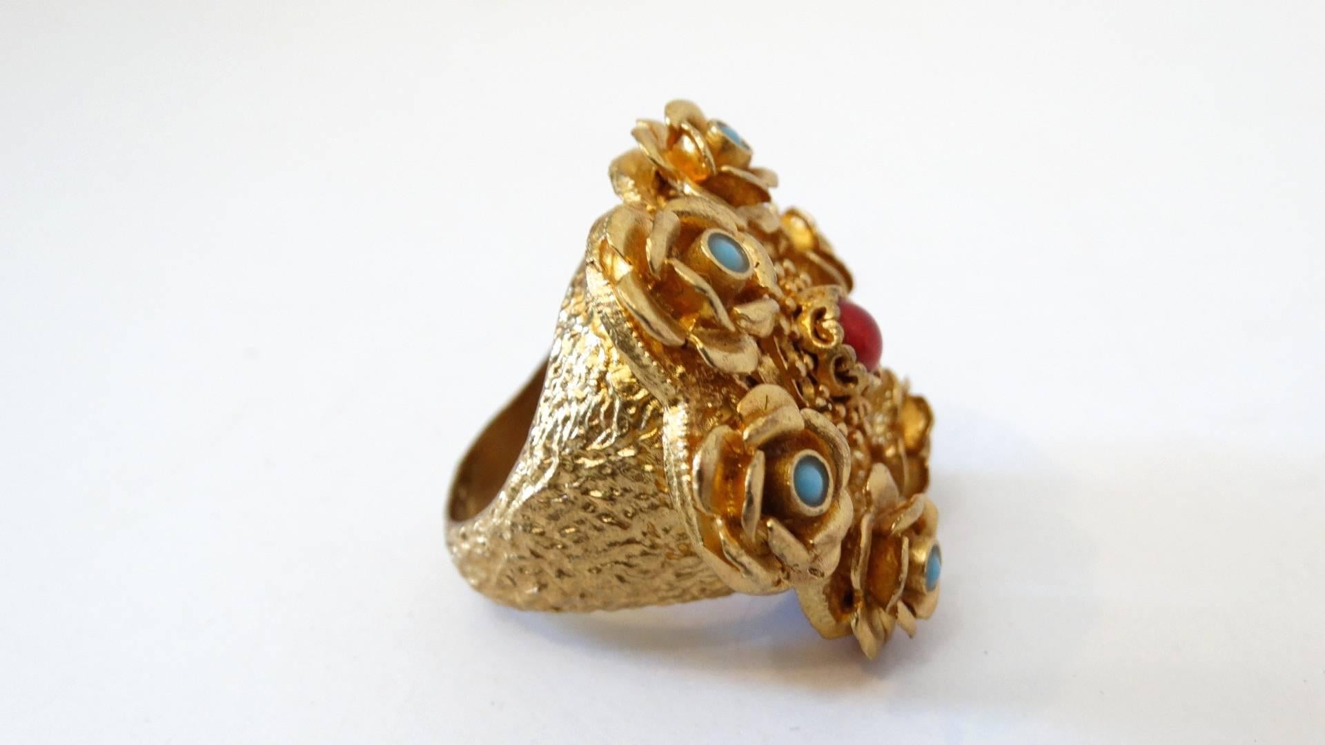Add a little opulence to your ring collection with our amazing Turkish cocktail ring! This piece is vermeil, made of a solid copper then plated in gold. Features a red coral stone at the center with 6 small turqouise stones set into gold roses.
