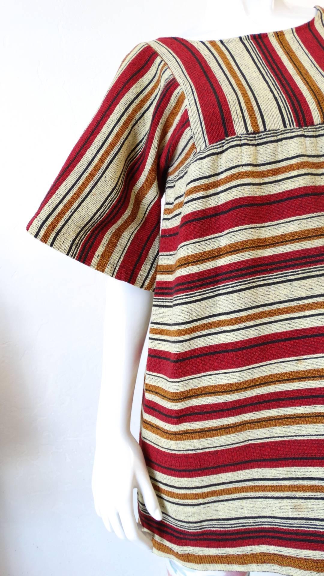 We are obsessed with Israeli label Rikma- and you will be too with this amazing 1970s striped bell sleeve blouse! Made of a thick, quality woven cotton fabric with signature Rikma stripes in shades of red, mustard and black. Trapeze style silhouette