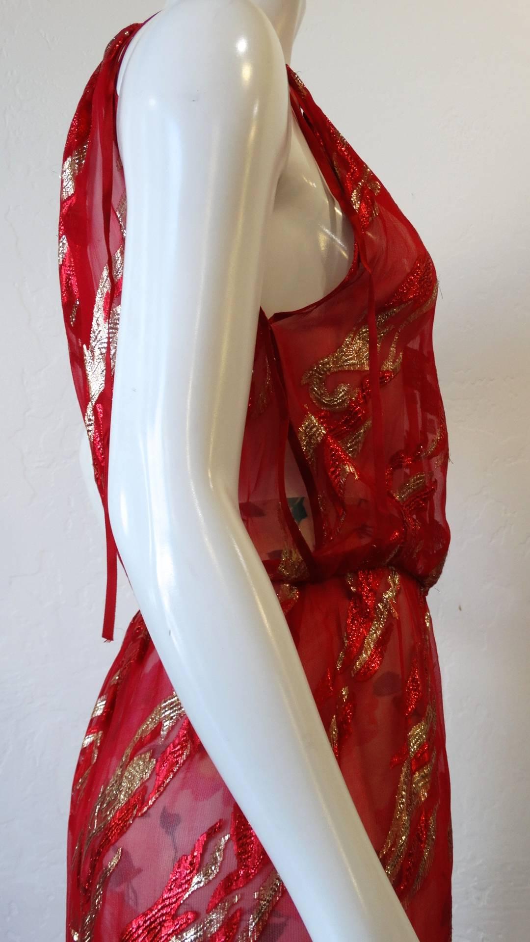 Gorgeous 1980s Saint Laurent Rive Gauche red sheer halter dress! Made of a red sheer chiffon fabric with woven metallic flame-like pattern throughout. Ultra-sexy silhouette with long slit up the left leg, perfect for showing off a thigh high boot.