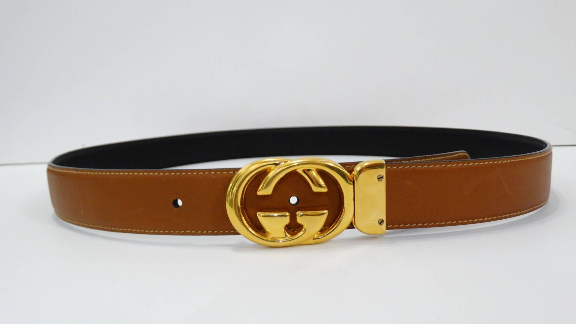 Score yourself a piece of classic Gucci with this amazing reversible Marmont belt from the 1980s! Signature Gucci GG buckle cast in a brilliant gold metal, turns to either side for reversible wear. Double sided belt with tan leather on the exterior
