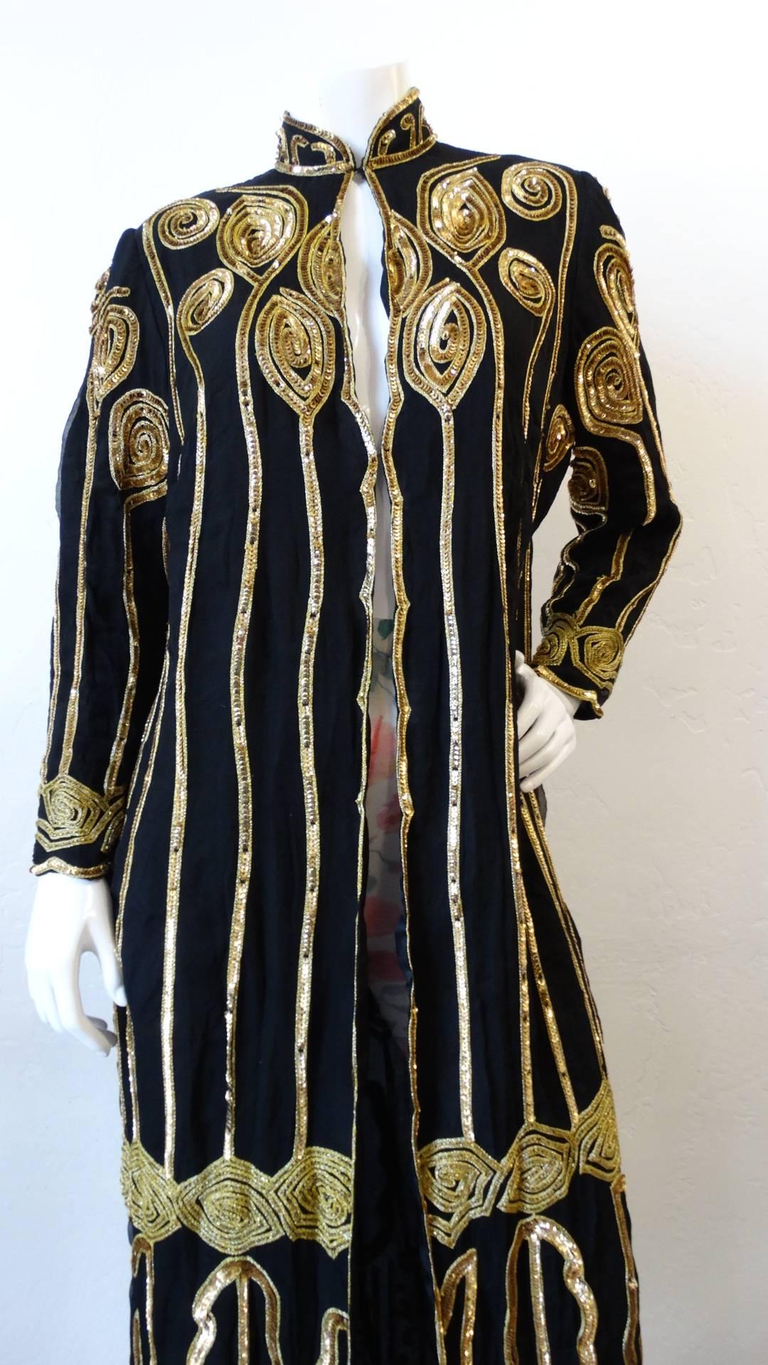 Glam up your evening wardrobe with our amazing 1980s black & gold embellished duster jacket! Constructed from solid black fabric and embellished all over in gold cord, embroidery and sequins. Long vertical stripes of sequins sewn down the front of