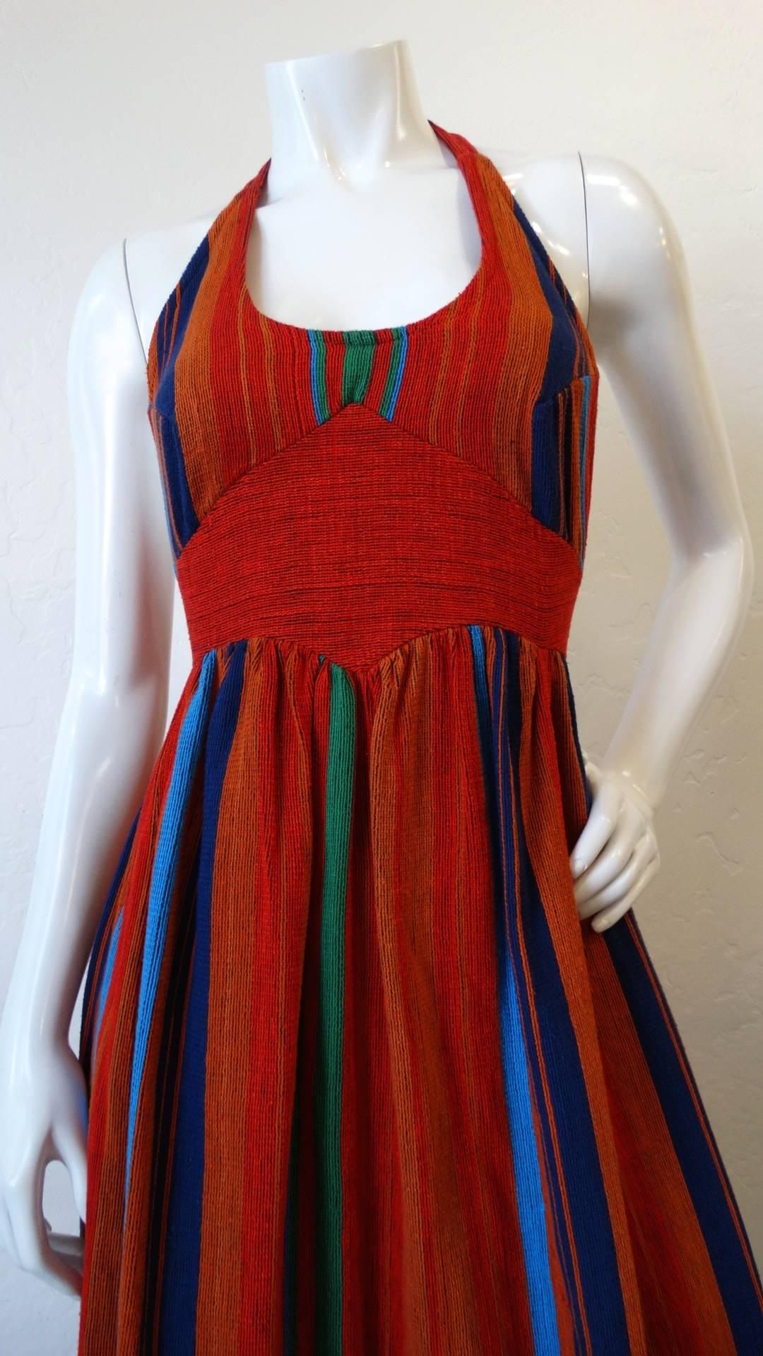 We're falling in love with Israeli designer Rikma- and you will too with our amazing 1970s halter dress! Made of a thick woven cotton fabric in Rikma's signature striped pattern in shades of red, orange, blue and green. Halter style silhouette with