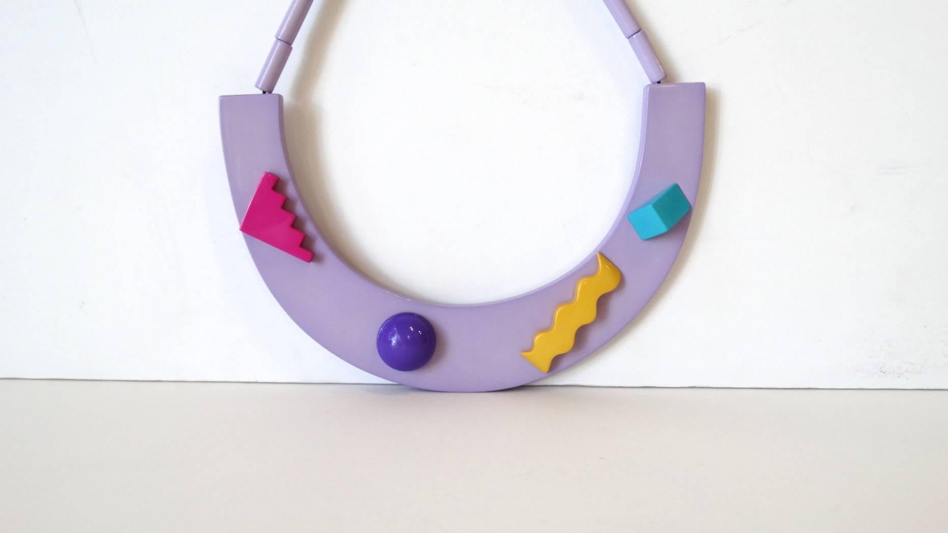 This abstract and multicolored necklace is a statement piece made for anyone! This piece exhibits influence from the Memphis Milano Movement.. Unique, structural and colorful, this lavender necklace adds flair to any outfit!

From the 70′s, would
