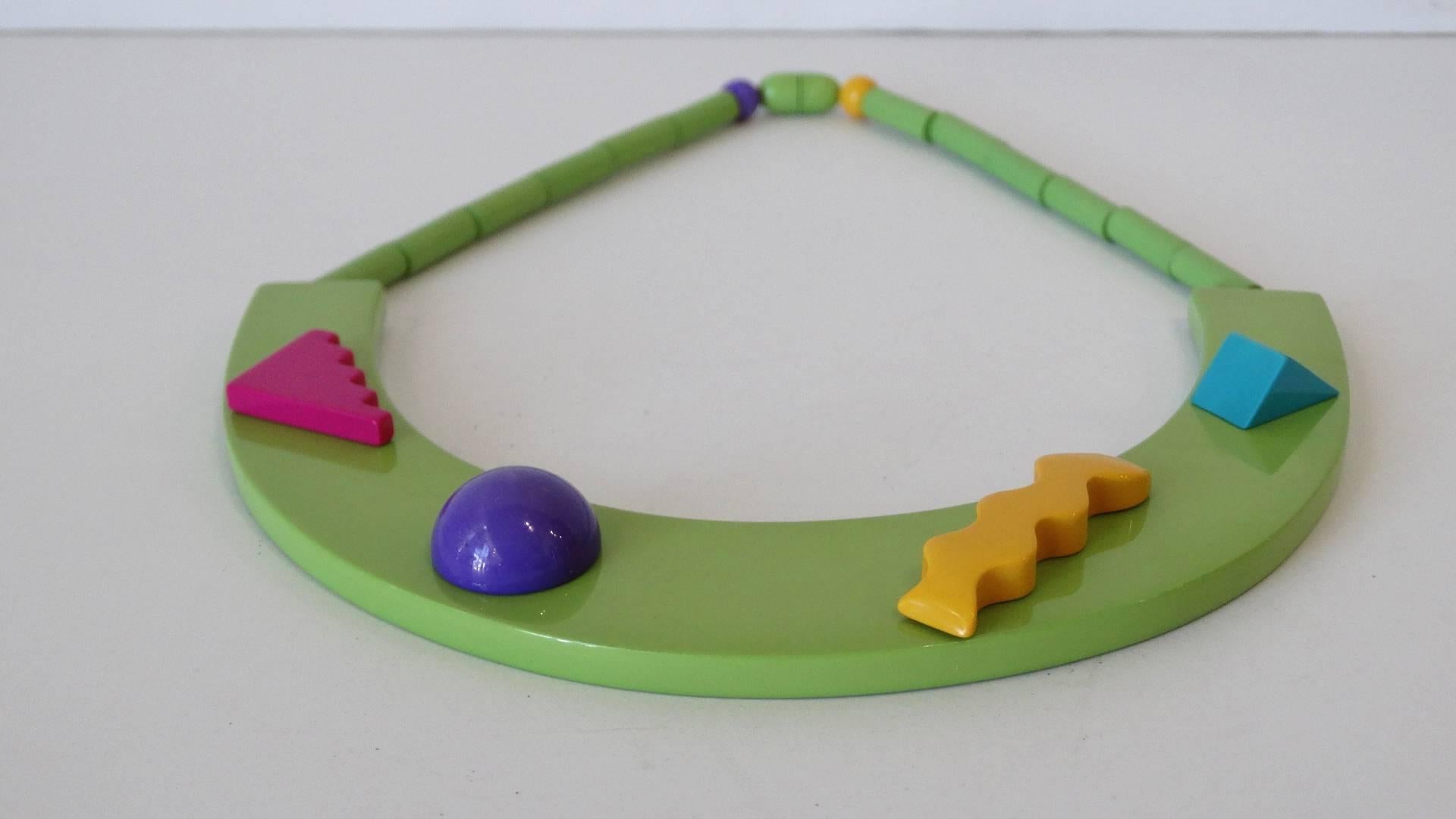 This abstract and multicolored necklace is a statement piece made for anyone! This piece exhibits influence from the Memphis Milano Movement. Unique, structural and colorful, this apple green necklace adds flair to any outfit!

From the 70′s, would