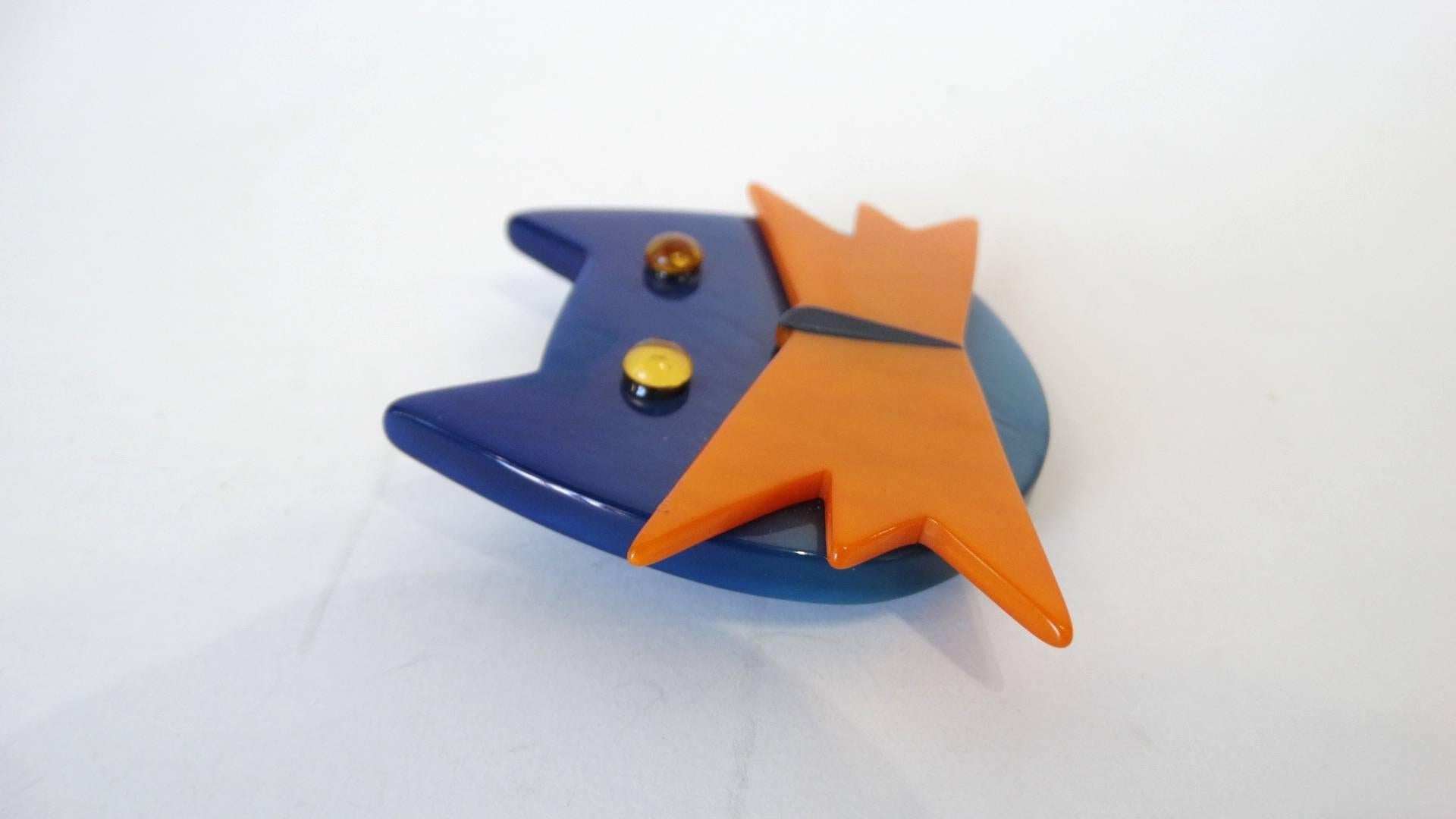 Add some quirk to your brooch collection with our adorable cat brooch from Marie Christine Pavone! Cat constructed from contrasting blue and orange bakelite and accented with two orange rhinestone gems for eyes. Pin back, signed Pavone. 

Brooch