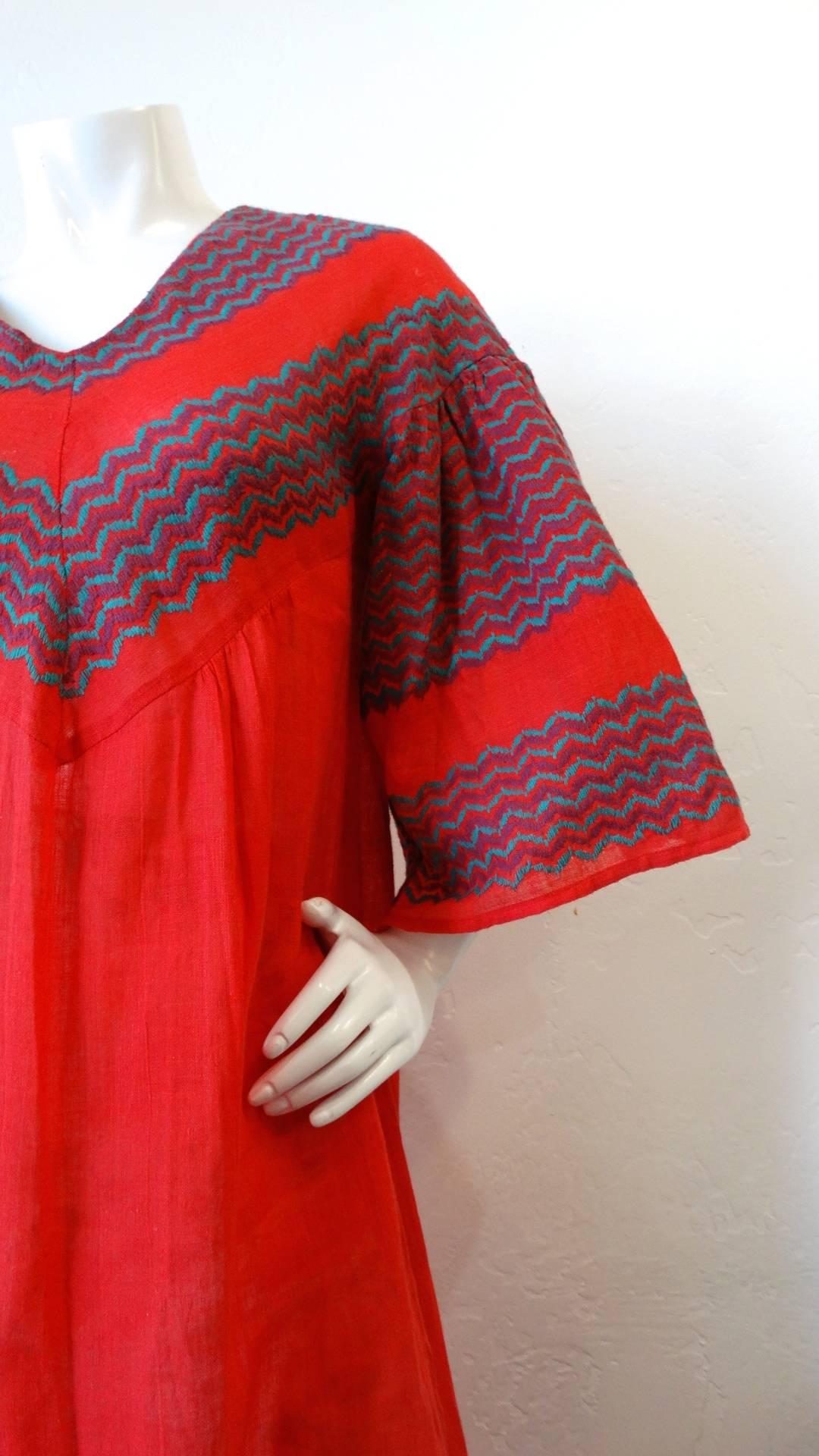 Incredible 1970s red chevron bell sleeve dress from Israeli designer Rikma! Made of Rikma's signature quality woven cotton in bright red. Semi sheer fabric accented by chevron stripes up the bust and sleeves. Maxi style length with flared, bell
