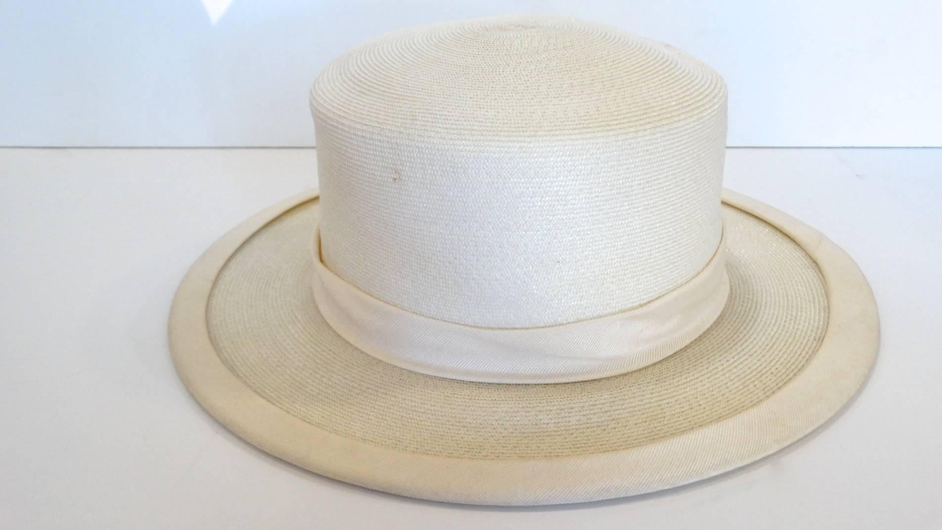 Panama meets the 70's! This exquisite panama style hat features a wide brim, with a gross grain sash, and adorned with two pom poms. The perfect summer hat!
This hat measures 3.5