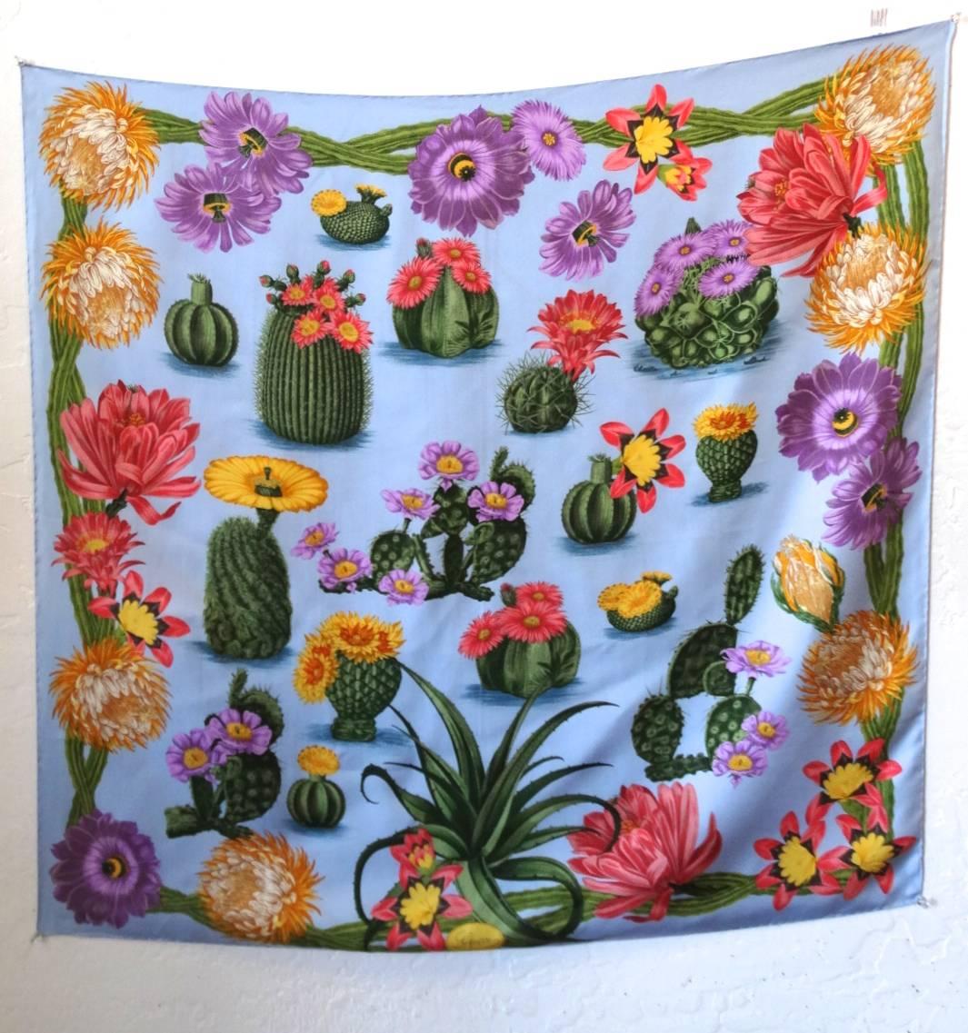 From the Gucci Cacti Flora Capsule Collection, this rare Gucci Cacti Silk Scarf is the most adorable piece to add to any outfit! The beautiful light blue is the perfect background color for the array of vivid Cacti. Show off this novelty scarf as a