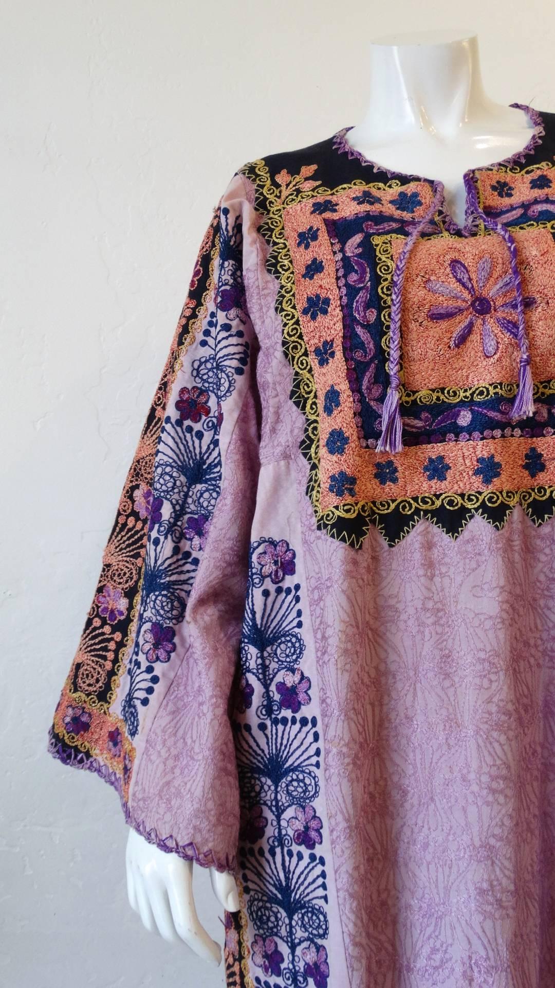 Incredible 1970s Bedouin embroidered kaftan dress! Made of a breezy cotton fabric and embroidered all over with an intricate floral inspired pattern! Oversized, kaftan fit with long flared sleeves. The perfect piece to throw on with your favorite