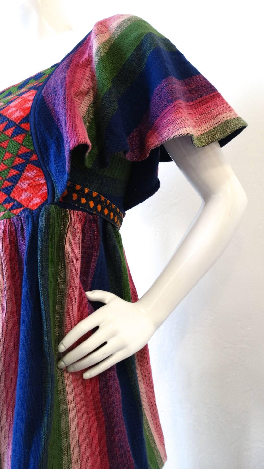 We love a good piece from Israeli designer Rikma- and you will too with our amazing 1970s Butterfly Sleeve top! Made of Rikmas signature thick woven cotton in a striped pattern, shades of pink, violet, blue and green! Empire waisted fit with a tie
