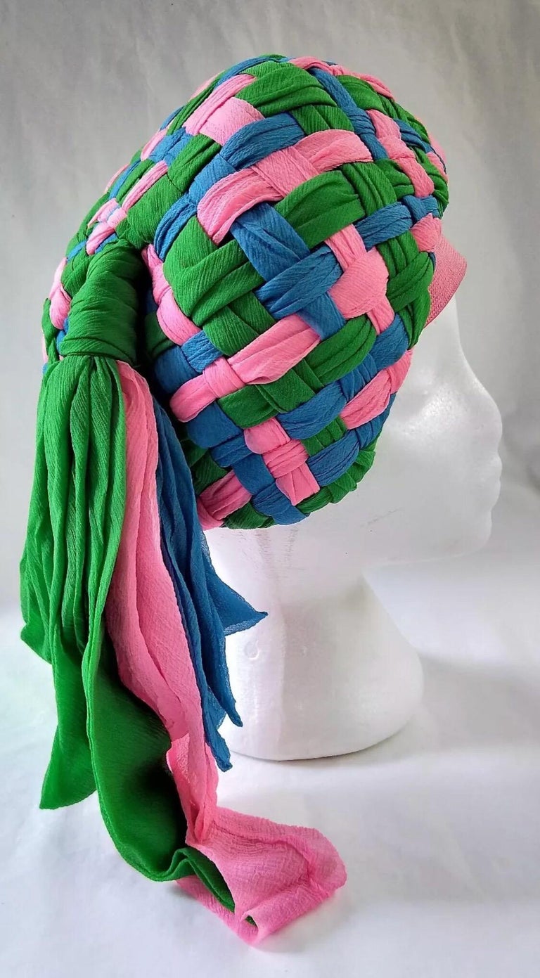Beautifully constructed 1960's Mr Individual, Melbourne Turban hat made of chiffon that is interwoven in hot pink, emerald green and blue with a fun side tassel. Made forsale in Myers Melbourne Emporium by highly regarded Milliner. Inner