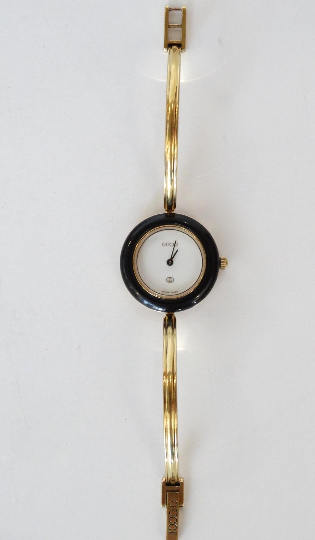 Have a Gucci watch for every day of the week with our watch and bezel set! Comes with gold metal Gucci bangle watch and original box full of 12 colorful bezels. Includes green and red classic stripe Gucci bezel.  Wrist Size (tip to tip) 5.60