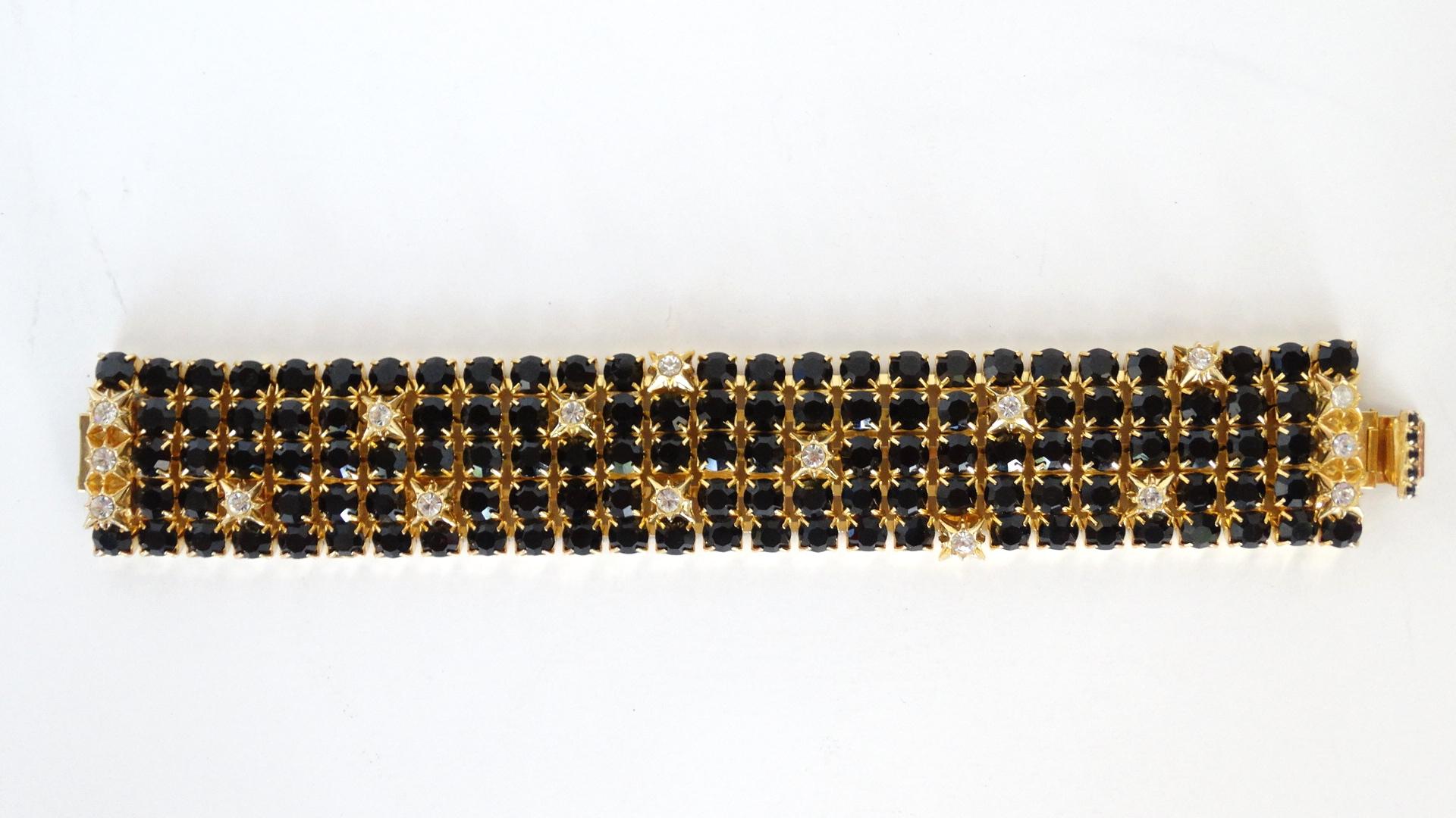 A beautiful 5 row black rhinestone bracelet created by William de Lillo in the late 70's. This bracelet features clear starburst rhinestones thru out. 8 inches in length 