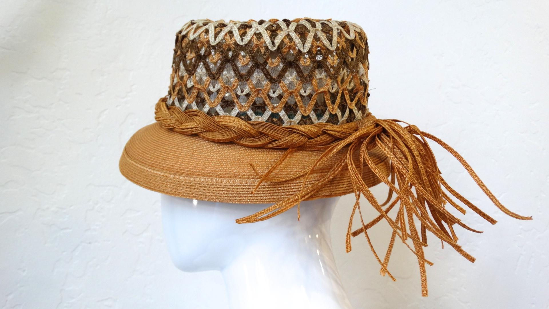 This amazing 1960s Yves Saint Laurent hat is a unique twist on the traditional boater style! Made of a quality woven straw material in contrasting shades of tan, brown and cream in an open weave at the top. Braided around the base of the hat with a
