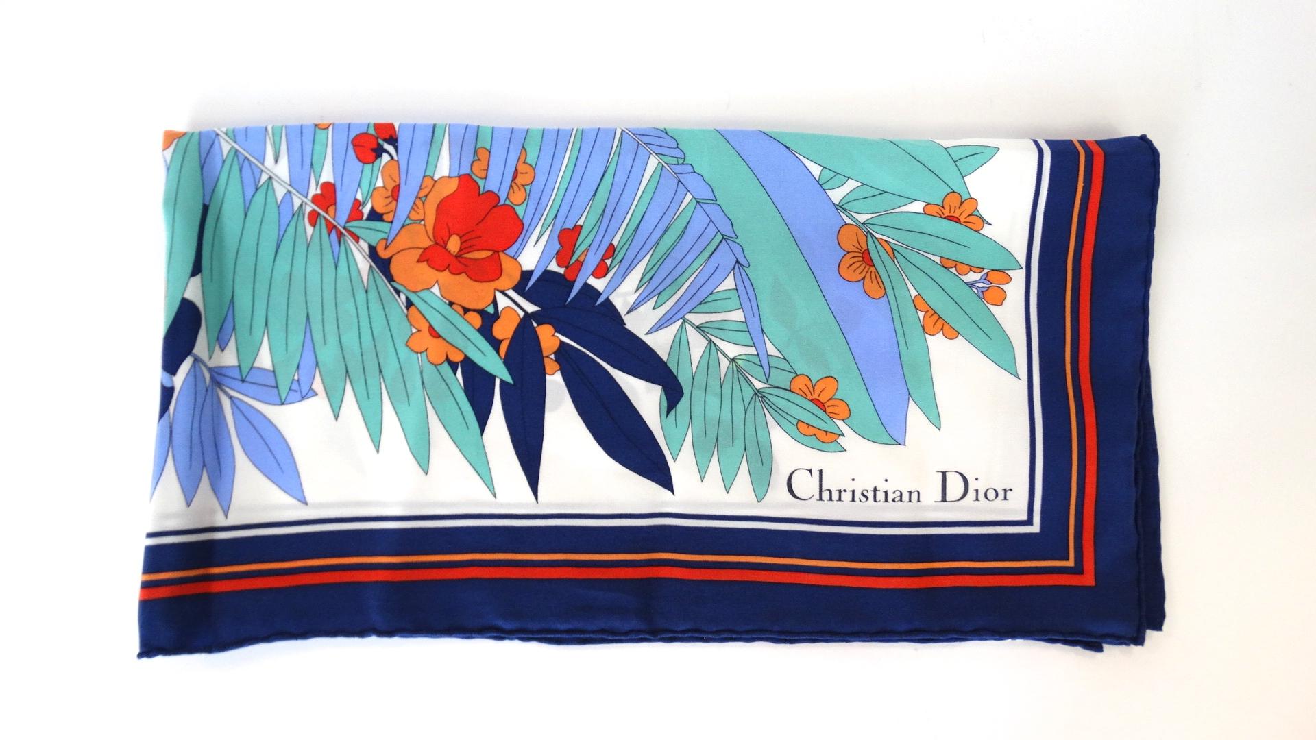 We love a good silk scarf for summer- and you will too with our adorable tropical printed silk scarf from none other than Christian Dior! Quality silk fabric printed with colorful palms and hibiscus flowers in shades of teal, blue, orange and red.