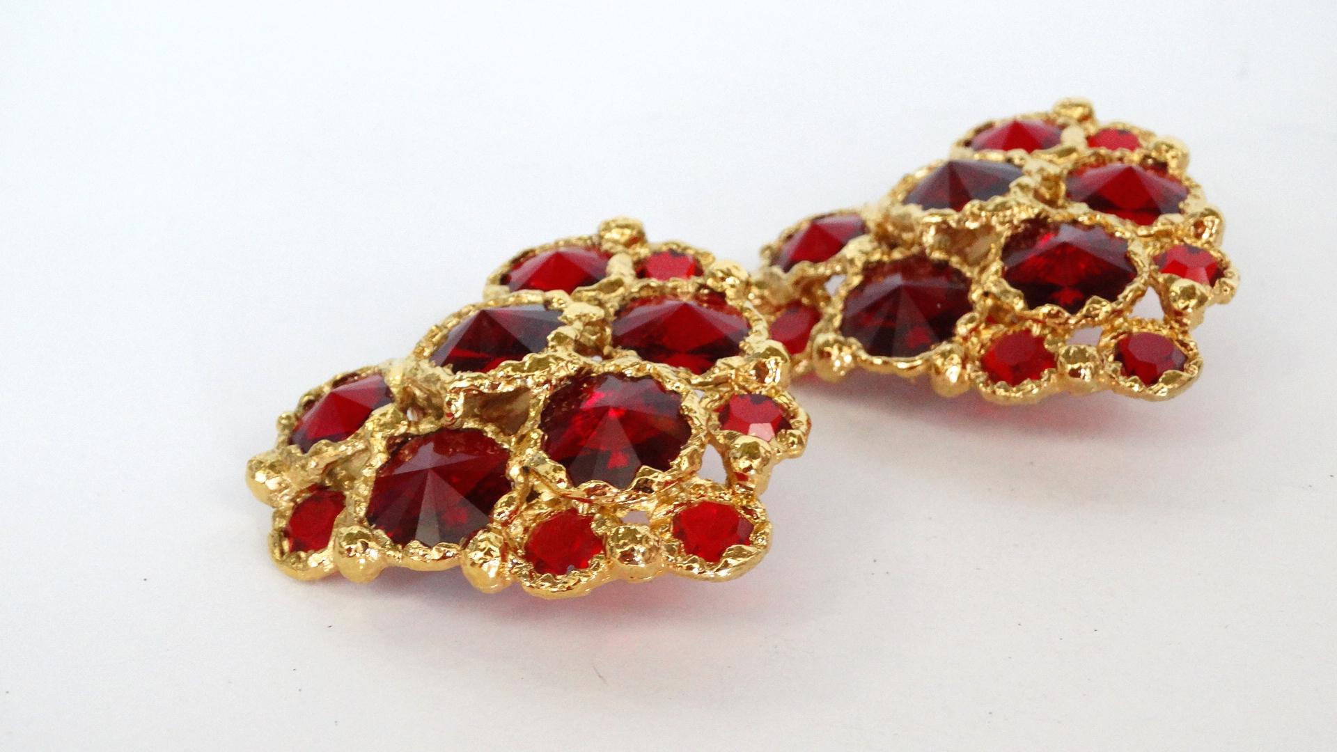 Spread the love with these Christian Lacroix heart shaped statement earrings! Circa 1980's, these clip-on earrings are crumpled textured gold plated with red gripoix gems throughout. Signed Christian LaCroix Made in France on the back of earrings.