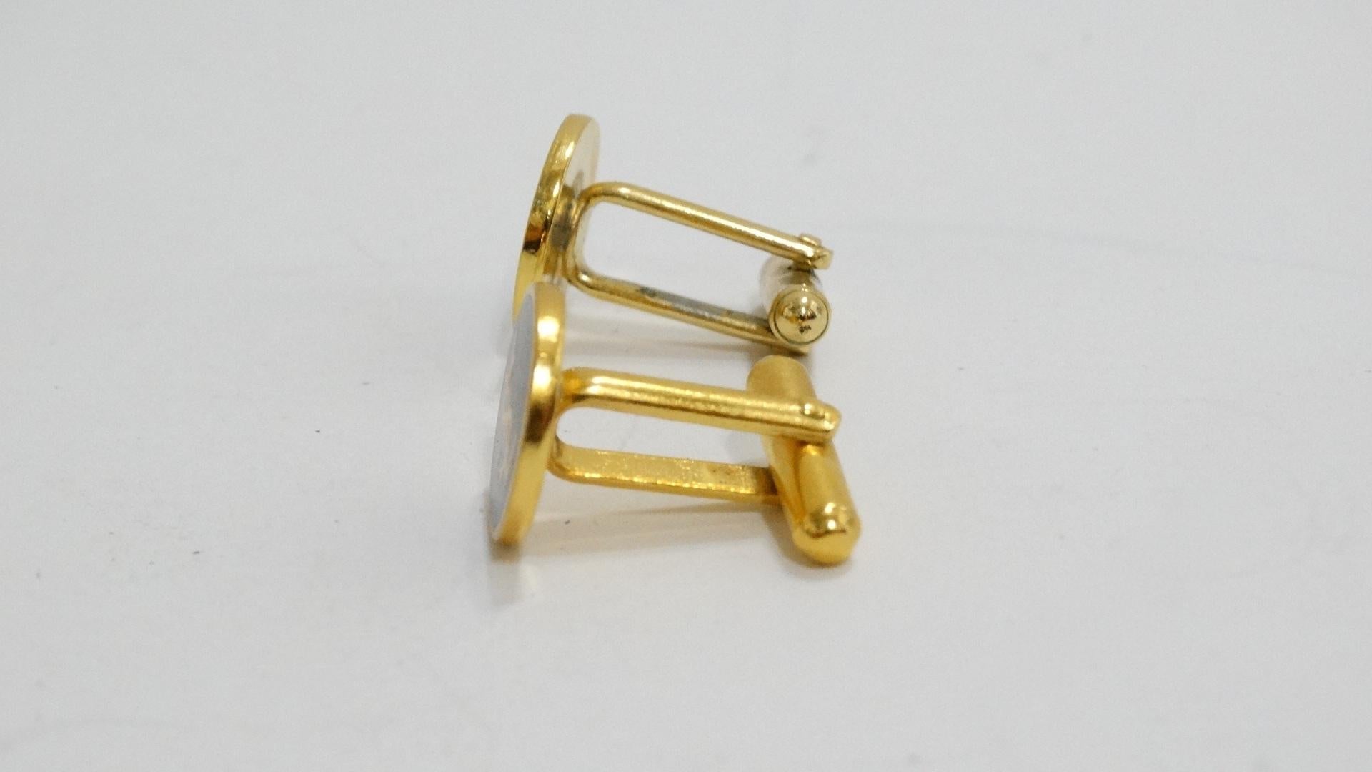 The perfect little accessory! Beautiful unisex cuff links by Yves Saint Laurent YSL, Gold tone hardware with a black front face which visibly displays the YSL Logo on both cufflinks. Comes in original box.
