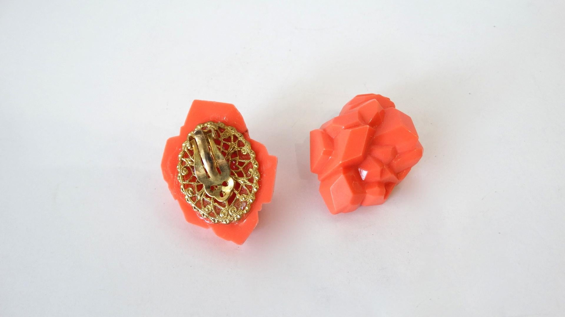 The best avant-garde earrings to add to your collection have arrived! Designed by William De Lillo, these three dimensional vibrant coral colored rock earrings have been sculpted into a piece of wearable art! Plated gold clip on backs and signed De