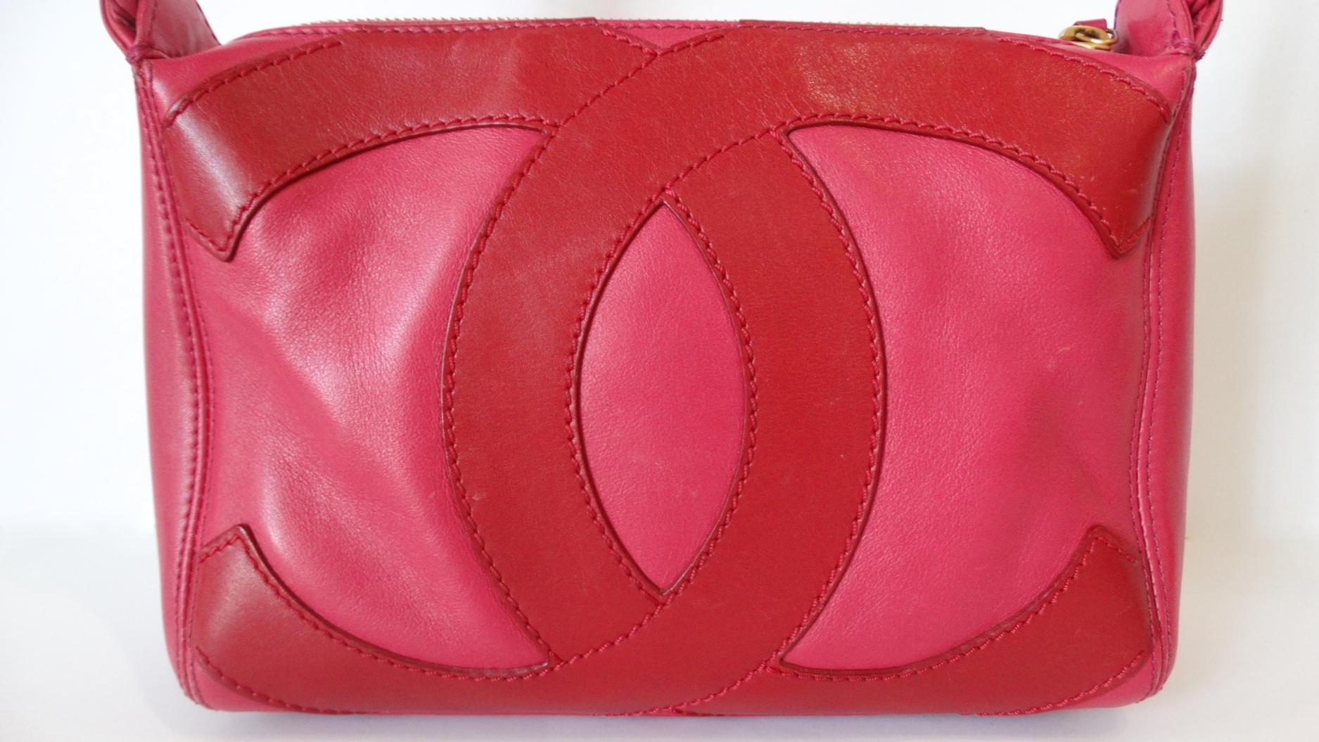 The Most Adorable 1990s Chanel Top Handle Bag Has Arrived! Made of a soft pink and lipstick red leather which feature the signature CC on the front and back. Open the zipper to find a lined interior decorated with the CC and Signed Chanel Made In