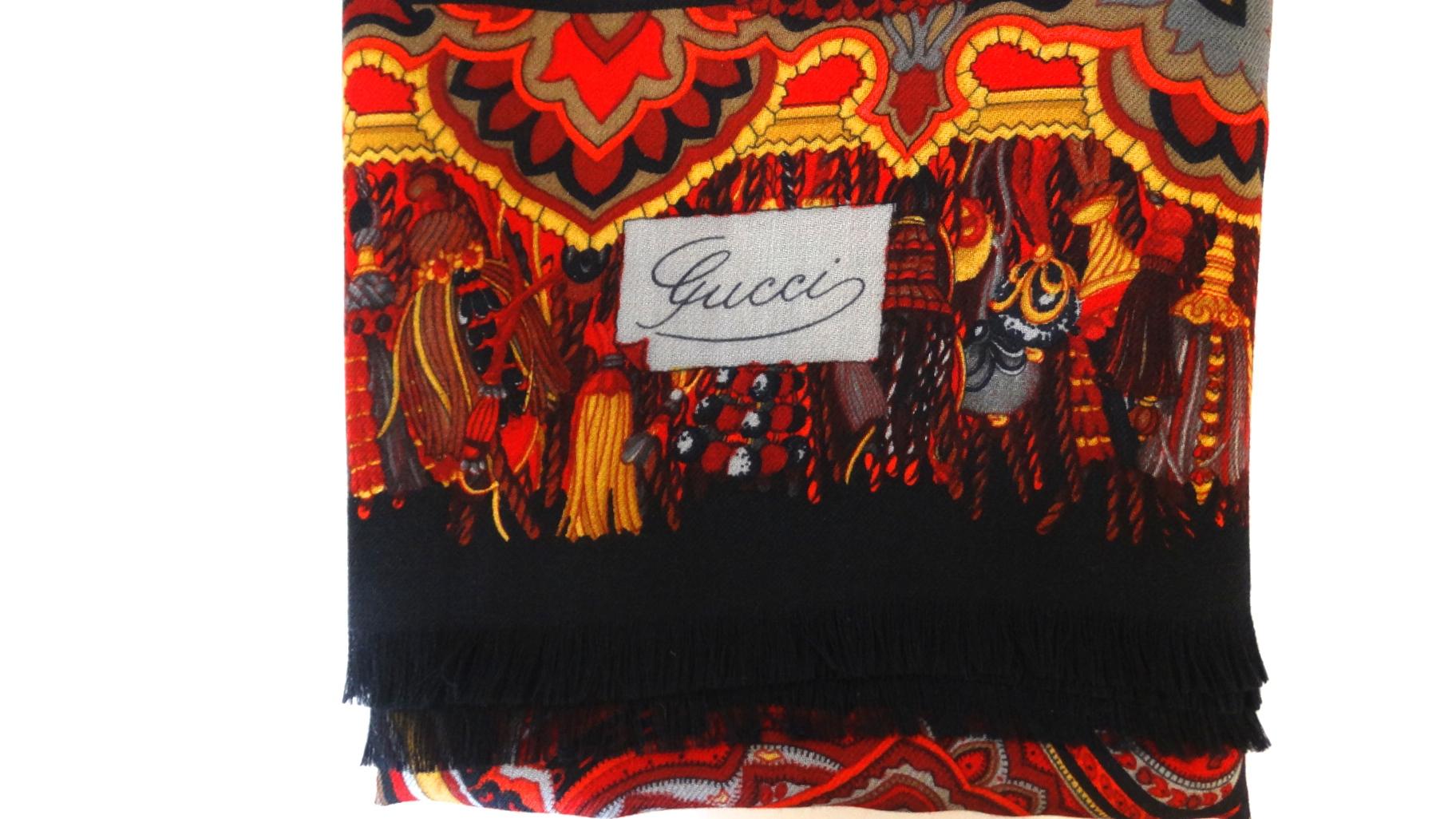 Amazing 1980s Gucci red paisley print shawl! Solid red background printed all over with an ornate persian rug inspired pattern! Super soft with lightly frayed black fringe all along the perimeter. Signed Gucci in cursive on the bottom corner. 