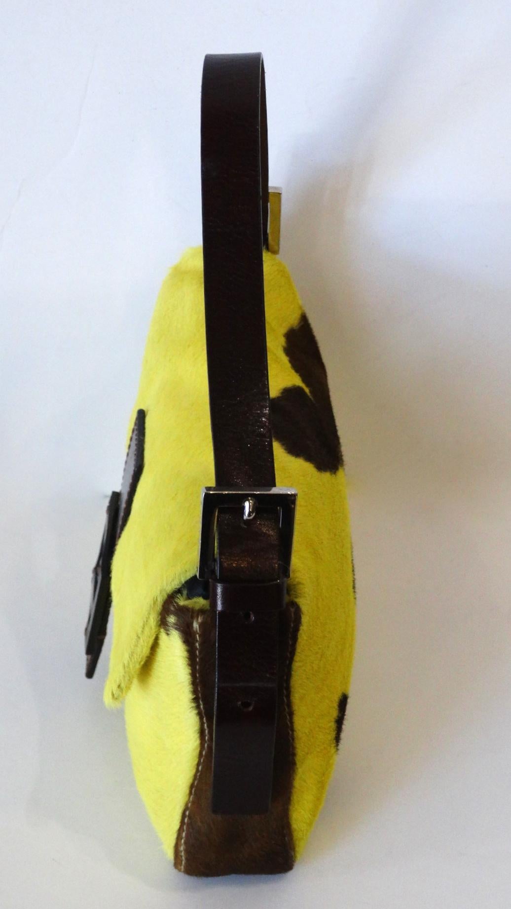 The most amazing version of the 2000s Fendi Baguette we've seen yet! Shocking bright yellow pony hair with contrasting dark brown cow spots on the back. Dark brown leather stitched around the clasp, featuring matching brown Fendi Monogram hardware.