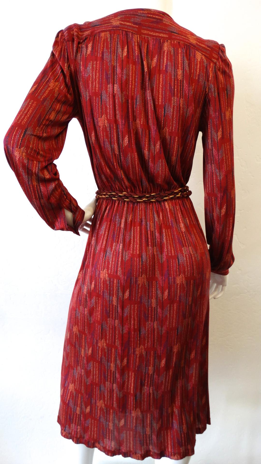 Your Perfect Fall and Holiday Dress Has Arrived-with our silk Missoni wrap dress circa 1970s! Featuring a rich cherry red color which stands out against the unique and colorful abstract tribal inspired print. Features cuff sleeves and strong