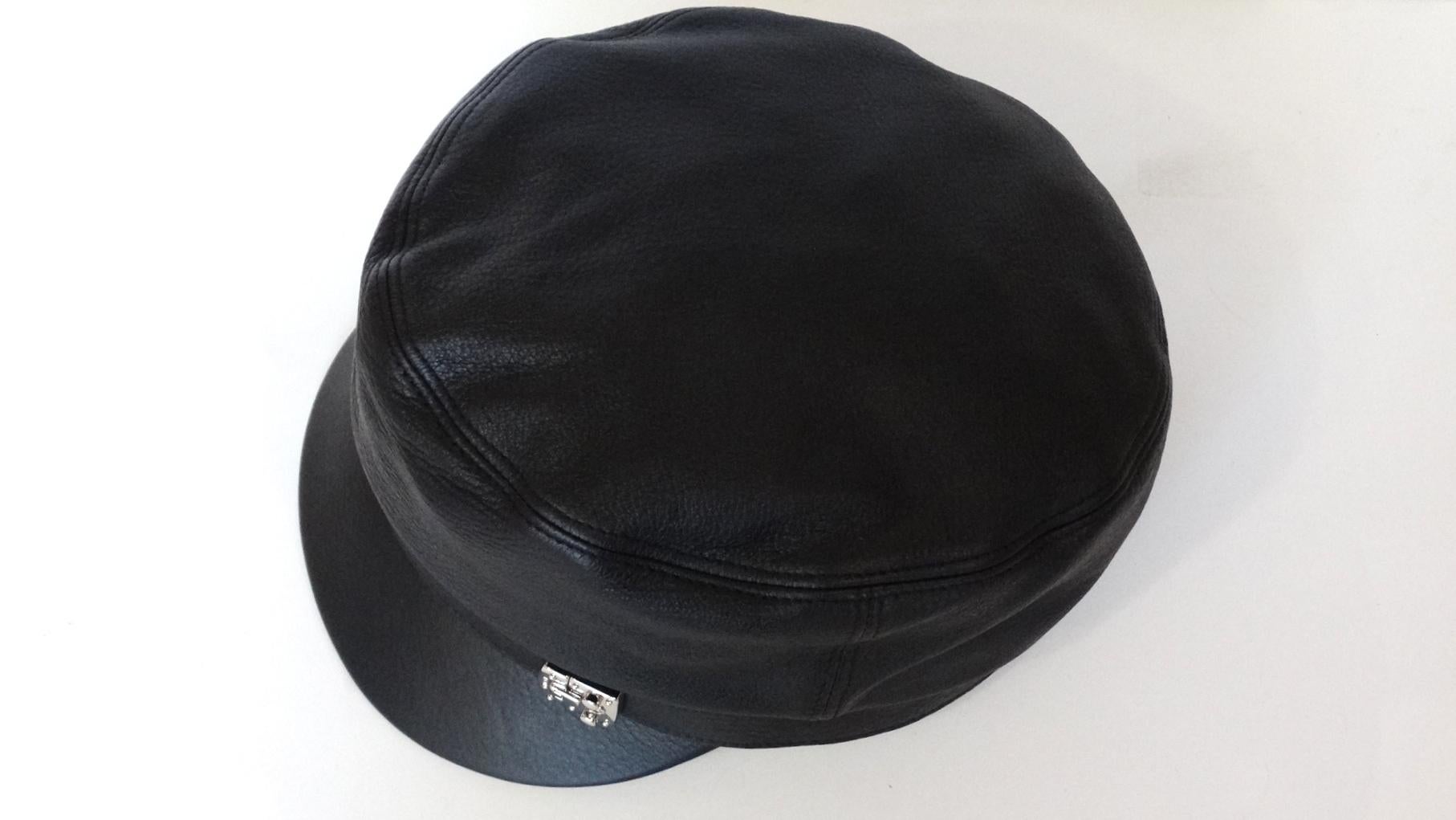 How Could You Not Be On Board With This Adorable Gucci Hat! From the 2000s, this Train Conductor style hat is made from 100% leather with a pebble grain effect and lined on the interior. Featured on the leather hat band is a Silver Gucci buckle for