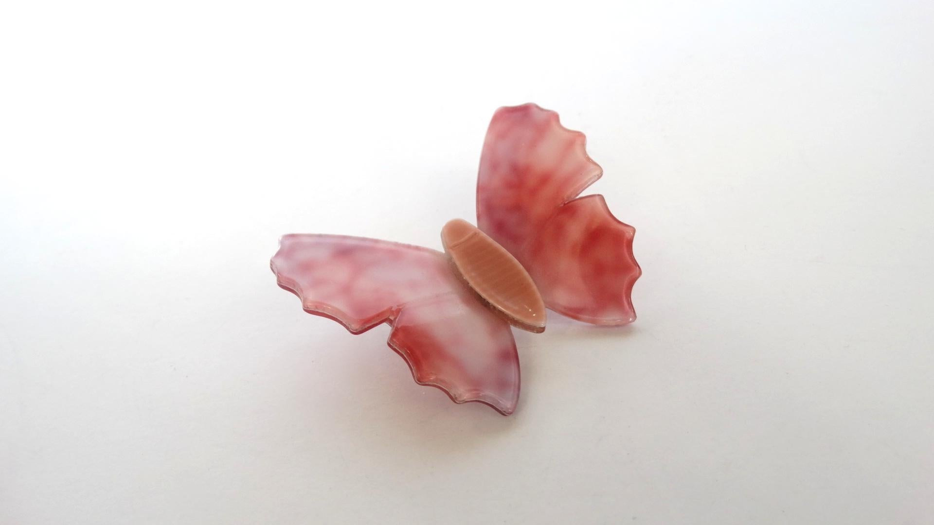 Brooches Are The New Hot Accessory This Season And We've Got You Covered! Circa 1970's, this Lea Stein butterfly brooch features an elegant marble effect in soft pinks. Simple cut out edging resembles the delicate details on a butterfly's wing. This